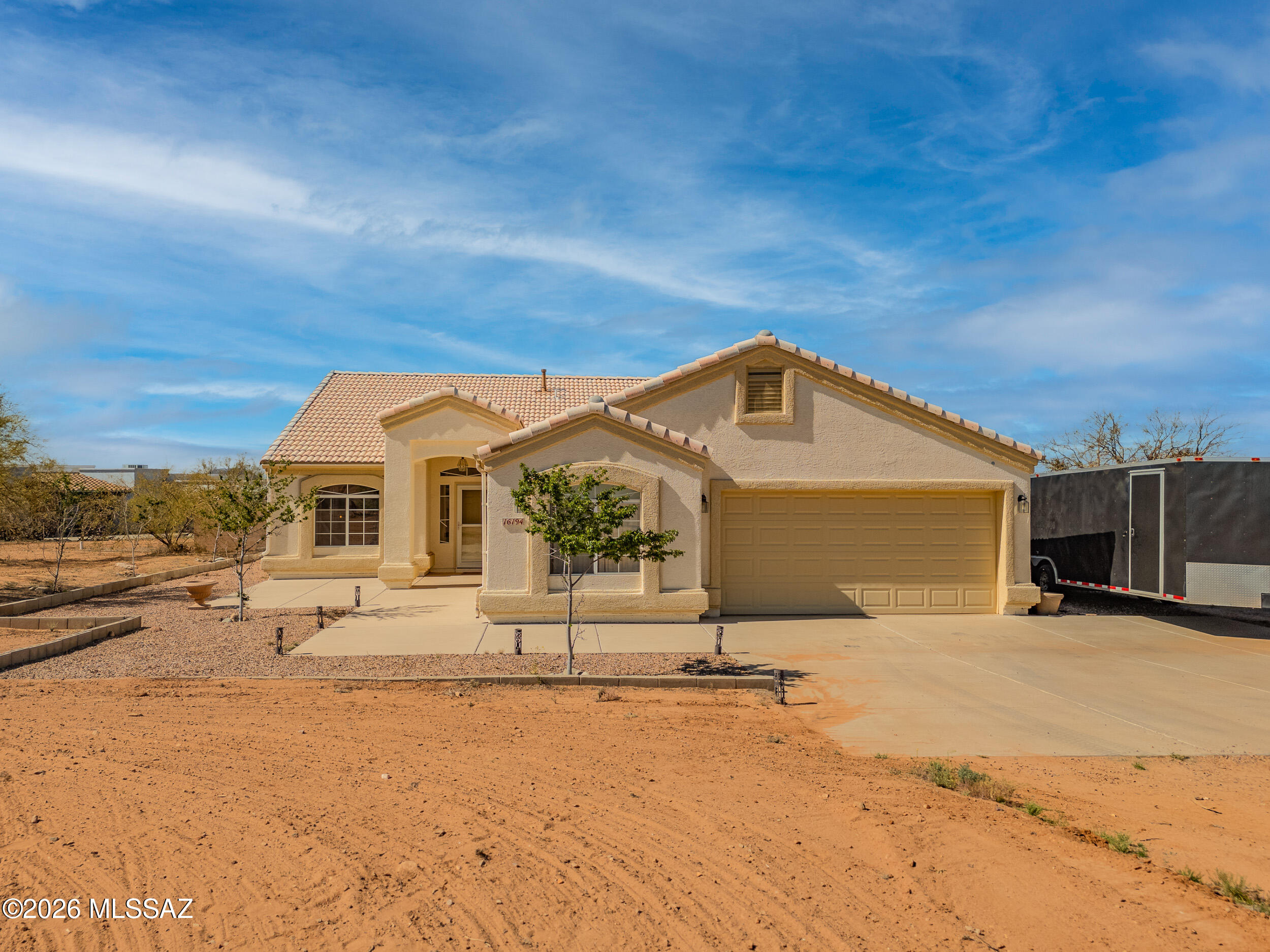 Enjoy stunning Arizona sunsets and mountain views from this unique property featuring 2.6 total acres across two parcels sold together as one. Sale includes the home site plus the adjacent 1.26-acre parcel immediately to the east (Tax Code 301-67-3110).
Inside, the home offers an immaculate kitchen with ample cabinetry, stainless steel appliances, granite countertops, and Mexican tile backsplash. The breakfast area features a bay window, and the center island with breakfast bar adds extra prep and seating space. The primary suite includes a wall niche, dual sinks, and a walk-in closet, while the guest bath has been upgraded with dual sinks. Outside, the cement block-fenced backyard is ready for entertaining. An oversized garage provides plenty of room for storage or toys, and the electrically wired shed offers added flexibility.