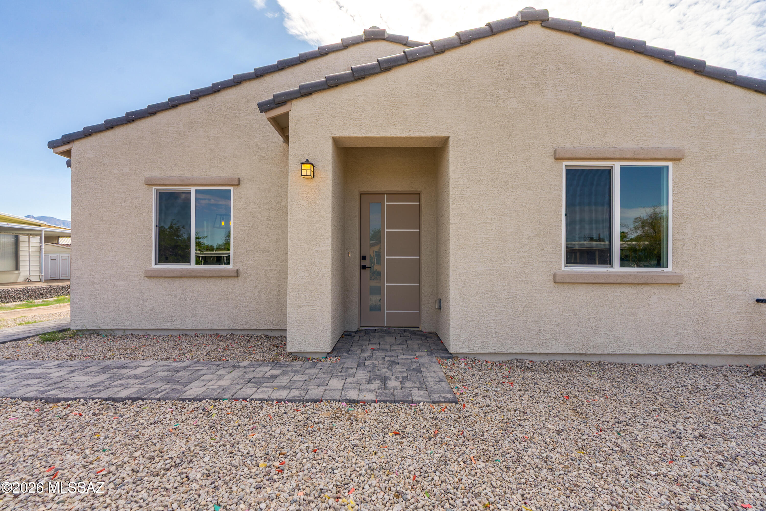 New Construction! Beautiful 3-bedroom, 2-bath home featuring tile flooring throughout for durability and easy maintenance. The home offers modern tiled showers and a spacious kitchen with sleek custom cabinetry, perfect for cooking and entertaining. The entire property is fully enclosed by a block wall, offering privacy, security, and peace of mind. Great location close to Tucson Mall, with convenient access to shopping, dining, and major roads. A great opportunity to own a brand-new home with modern finishes and a private setting. Photos are of a similar property and are for illustrative purposes only. Actual finishes and features may vary. Owner/Agent.