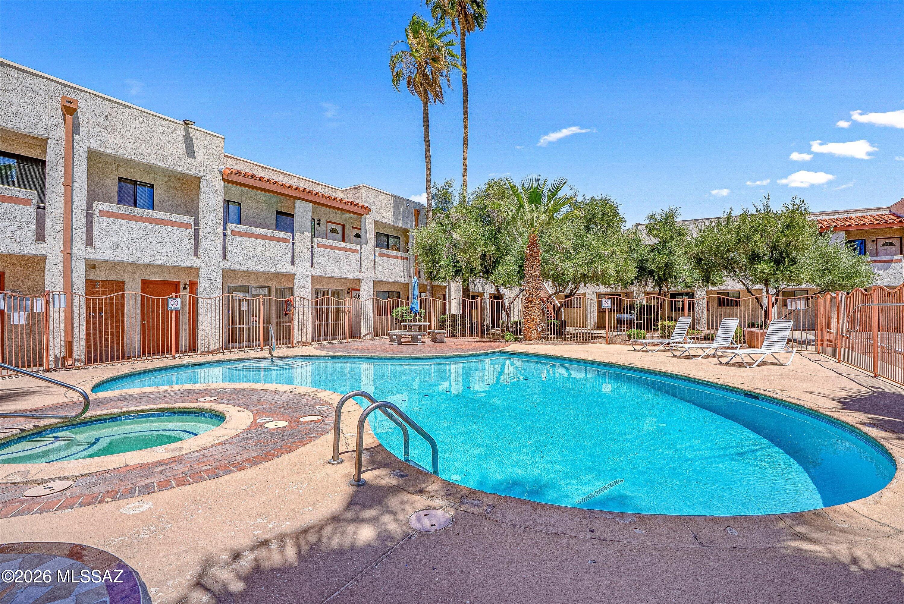 Perfectly located just minutes from the University of Arizona! This charming condo is ideal for students, winter visitors, or anyone seeking convenient central living! This spacious 1-bedroom, 1-bath unit overlooks the relaxing community pool and spa and features solid wood cabinetry, laminate wood flooring, and a skylight that fills the kitchen with natural light. The large bedroom offers comfort and functionality, while the secure gated community provides peace of mind. Additional amenities include one assigned parking space, on-site laundry facilities, pool/spa access, and HOA maintained grounds. Conveniently located near downtown Tucson, bus lines, shopping, dining, and entertainment. HOA covers water, trash, blanket insurance policy, and landscaping maintenance. Some furnishings may convey with the sale.