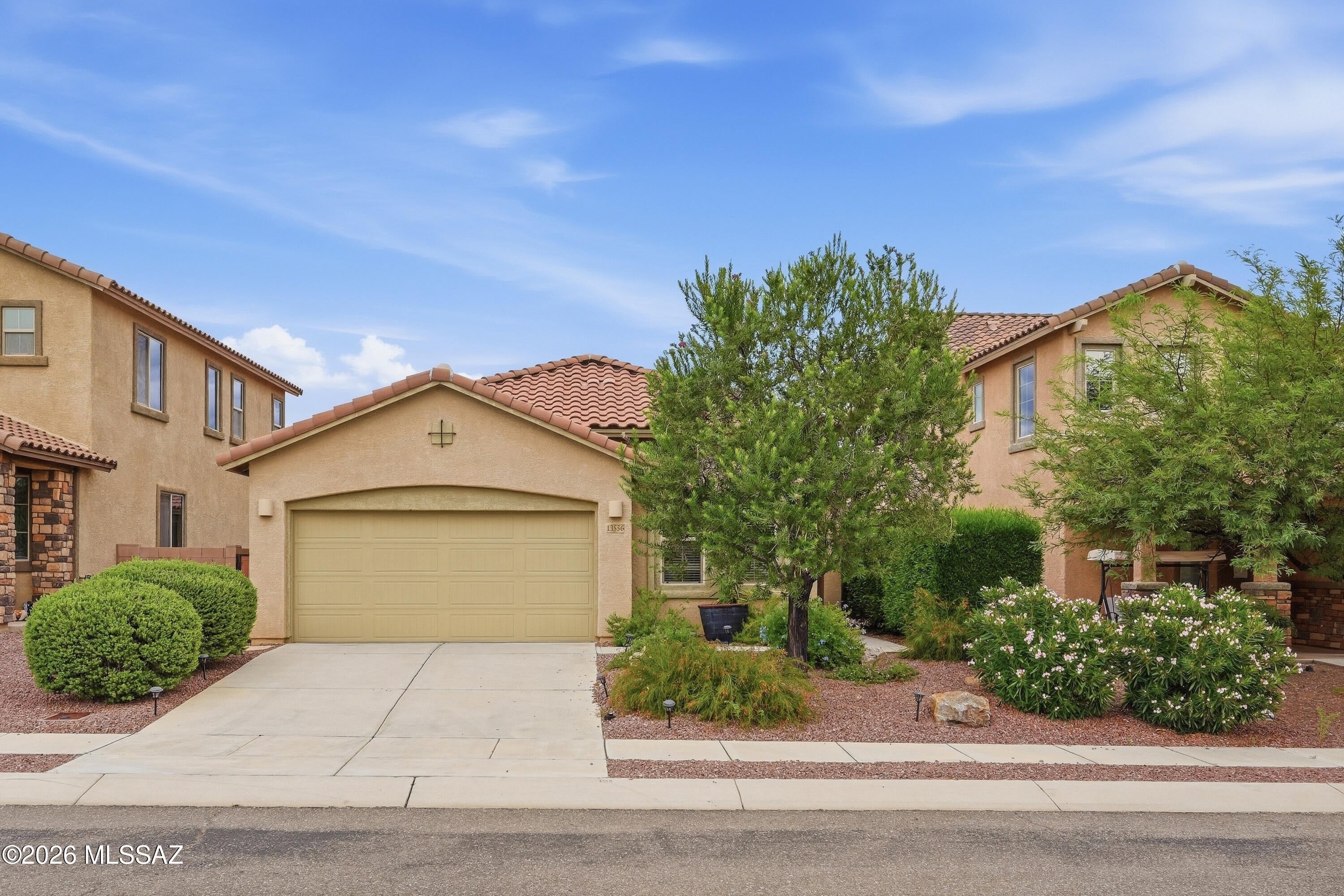 Welcome to this light-filled 4-bedroom, 2-bath home in Rancho Vistoso, where an open layout makes everyday living and entertaining easy. The split bedroom plan offers separation and flexibility, with the fourth bedroom well suited for a home office, hobby room or guests. The spacious kitchen features creamy cabinetry, tall upper cabinets and a breakfast bar overlooking the living area.

Step outside to a covered patio and an extended paver area with room to relax or gather. A large flagstone walkway winds through mature, easy-care landscaping, while mountain views add to the backyard setting. Enjoy nearby Honeybee Canyon Park, Rancho Vistoso parks, dog parks and bike trails. Oro Valley Marketplace, The Views Golf Club and Oro Valley Hospital are also a short drive away.