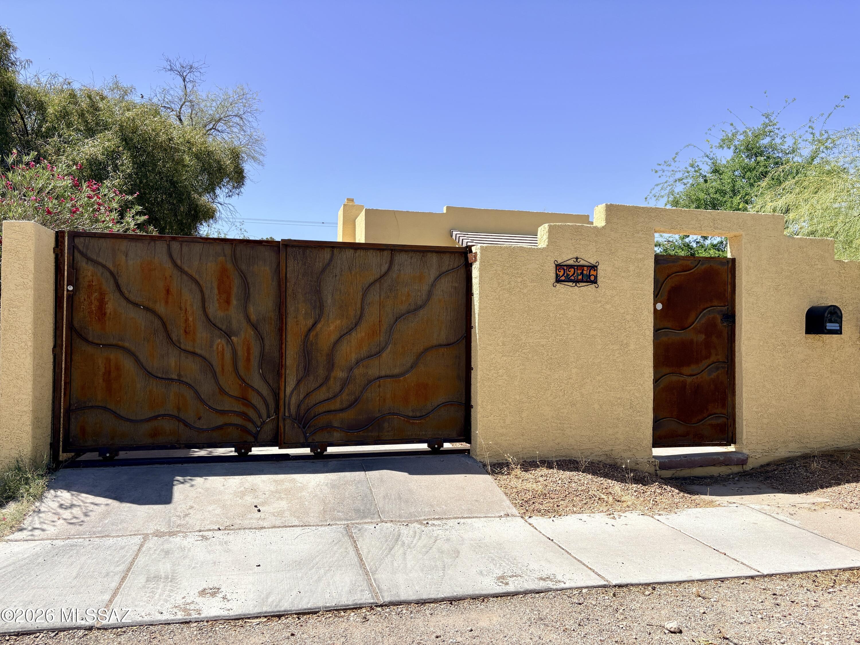 You don't want to miss this adorable, adobe and brick gated entry Tucson home! Located just three blocks from the University of Arizona, and very close to a bus stop for ease of transportation! Not to mention close by Banner University Medical Center, Flora's Market, Tumerico, Borderlands Brewing and within a few minutes drive to some of Tucson's best restaurants! You will have privacy in the historic and highly desirable Sam Hughes neighborhood. The home includes spacious living area, dining room and galley kitchen! All bedrooms are spacious and the back room has access to the back patio. Plus 3rd bedroom includes private bathroom and private access. Back yard has a very spacious patio with outdoor couch included. Shared yard with back tenant is gorgeously landscaped, too! Covered 1 car carport. Washer and dryer included! Pet Friendly. W/S/T included with flat rate. Property managed by owner.