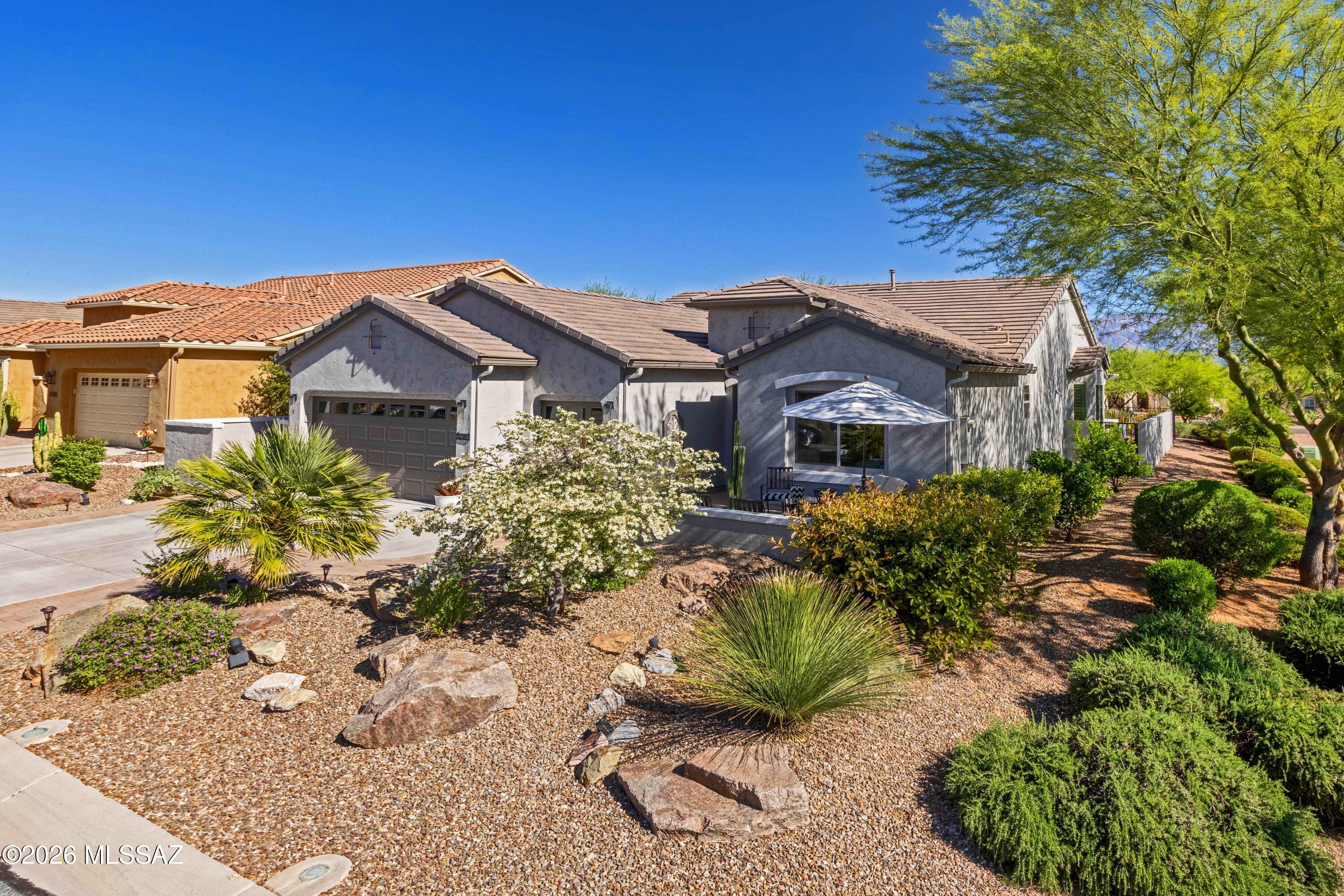 Majestic views of the jagged peaks of the Catalina Mts. highlight this 1844 sq. ft. highly upgraded/ modern/ beautifully maintained Dolce Model Design B at Saddle Brooke Ranch. This exquisite 2-bedroom, 2.5- bath home features added options including 4 ft. extensions to the Driveway; Garage, Primary Bath; a Golf Cart garage, and a Bay Window in the dining area. From the Coffee Patio at the entrance, you step Inside to the Great Room which transitions seamlessly into the Kitchen to an extended Island w/ seating, Glass Back Splash, Quartz Counters throughout, and upgraded Stainless-Steel Appliances. The home has a Powder Room, spacious Den that could be a 3rd Bedroom; extended Walk-in Closet in the Primary Suite, and Separate Laundry Room. When you walk into the Outdoor Living Space (336 sq. ft.) you experience a whole separate room to enjoy year-round with Rolling Shades; Built-in BBQ; Pergola; and lush mature trees and plants. The 5 ft. long gas fireplace creates a creative ambiance to entertain friends. Added Bonus: Newly Painted!
