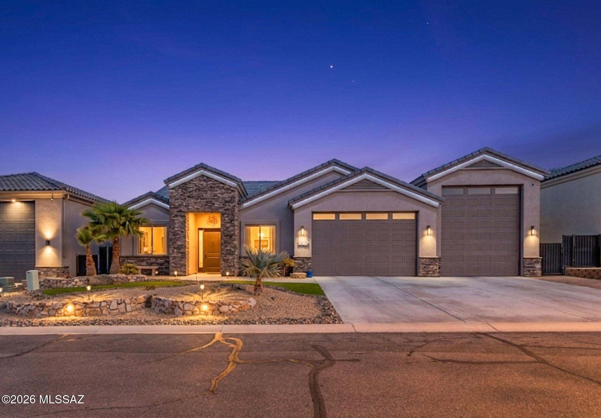 Beautifully upgraded Lake Havasu home with open-concept living, custom lighting, dimmable kitchen lights to balance circadian rhythms. Under/upper cabinet illumination. Kitchen includes 5-burner cooktop with cast iron skillet, pot filler, microwave/convection oven, wine cooler & Specialty stone countertops. A true chef's kitchen! Primary suite features tray ceilings, French doors with dark shades, walk-in custom tiled shower, quartz counters, and custom closet. Pebble Tec pool with grotto waterfall, Silver Travertine decking, rock fountain & shaded patio. 73-ft RV garage with UV-protected doors. 8-ft alder doors throughout the property, blinds in the living space are remote operated. All 4 bedrooms are spacious and private. Please see extended description for more upgrades!