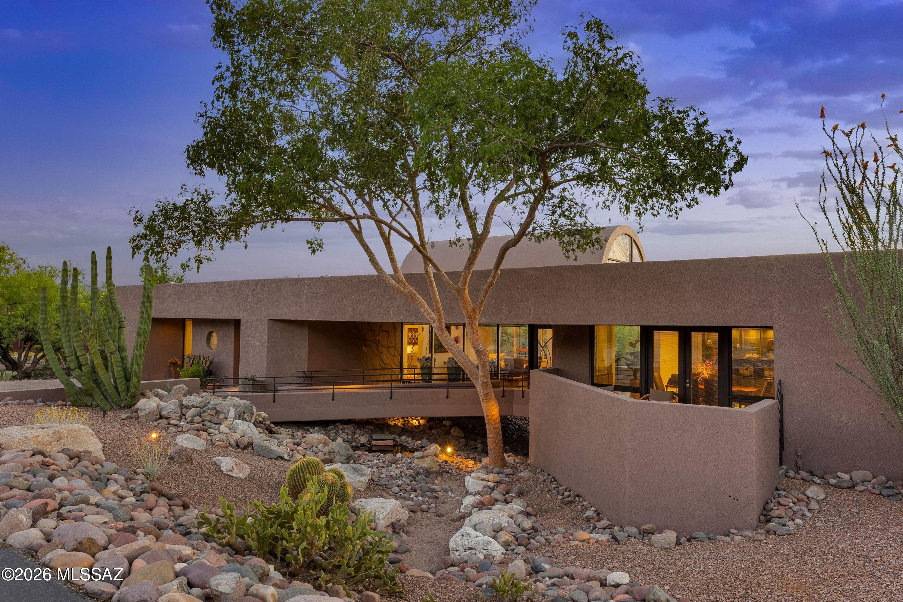 Discover a striking contemporary masterpiece designed by renowned architect John Campisano, perfectly positioned on the golf course in the prestigious Ridge Estates of La Paloma. Perched privately above the lush fairways, this exceptional residence captures sweeping desert vistas dotted with majestic saguaros and dramatic mountain views stretching across the horizon. Expansive walls of glass flood the home with natural light, seamlessly blending sophisticated interior spaces with the breathtaking Sonoran landscape. This large, thoughtfully designed home features 4 spacious bedrooms and 3,5 bathrooms, including a luxurious primary suite and a private mini-primary suite-ideal for guests or multigenerational living. Clean modern lines, open-concept living areas, 
and soaring ceilings create an atmosphere that is both refined and inviting. The chef's kitchen is appointed with a Viking gas range, Miele steam oven, Miele warming drawer, Miele coffee system, Bosch dishwasher, and Sub-Zero refrigerator. Step outside to your resort-style backyard where an infinity-edge pool appears to spill into the desert beyond, offering a stunning setting for sunset gatherings or quiet evenings under the Arizona sky. Complete with a 3-car garage and located within the highly desirable, manned gated community of La Paloma, this property offers privacy, security, and timeless architectural appeal-all in one extraordinary desert retreat only minutes away from golf, restaurants and shopping.