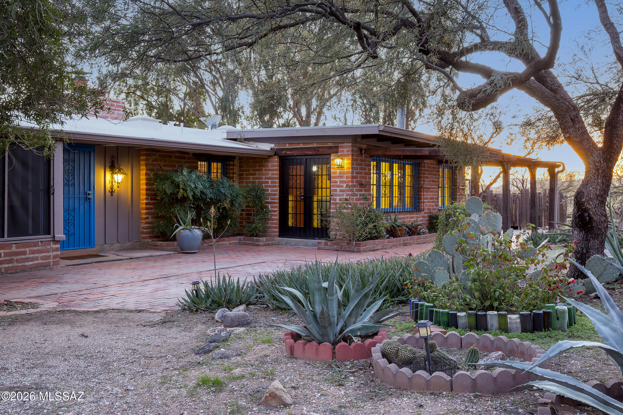 Now is the time to live your midcentury modern fantasy! This 1954 built William Hazard burnt adobe house and guest is the perfect place to show off your collection of googie gewgaws and smart retro furnishings. 4 beds/3 baths in the main, and 1 bed/1 bath in the guest. Beamed ceilings. Original wood floors. Stained concrete. Some vintage vinyl. Full of light. Perfect for entertaining. The great room is light-filled with access to the large screened in porch. Primary ensuite has its own private patio. Two other bedrooms are bright with sliding glass doors that open onto the back yard. An ideal setting for your Sonoran Desert indoor-outdoor lifestyle. The grounds are an expansive 3.41 acres with pockets of exotics surrounded by natural desert. Guest House is accessed by a short hike through the desert, or a drive down the long, long driveway. Private well. Close to central Tucson,  on the foothills side of the Rillito. Walk to the river path, or perhaps ride your horses? Zoned SR, possible rezone to RX1 and add additional casitas for the ultimate family/friend compound. This unique property has so much to offer!  

Some virtually-staged photos are provided to prime your imagination. And you can get the real feel from your phone or computer by checking out the flythrough and virtual tour. Call your agent to come take a look and visualize what could become your reality.