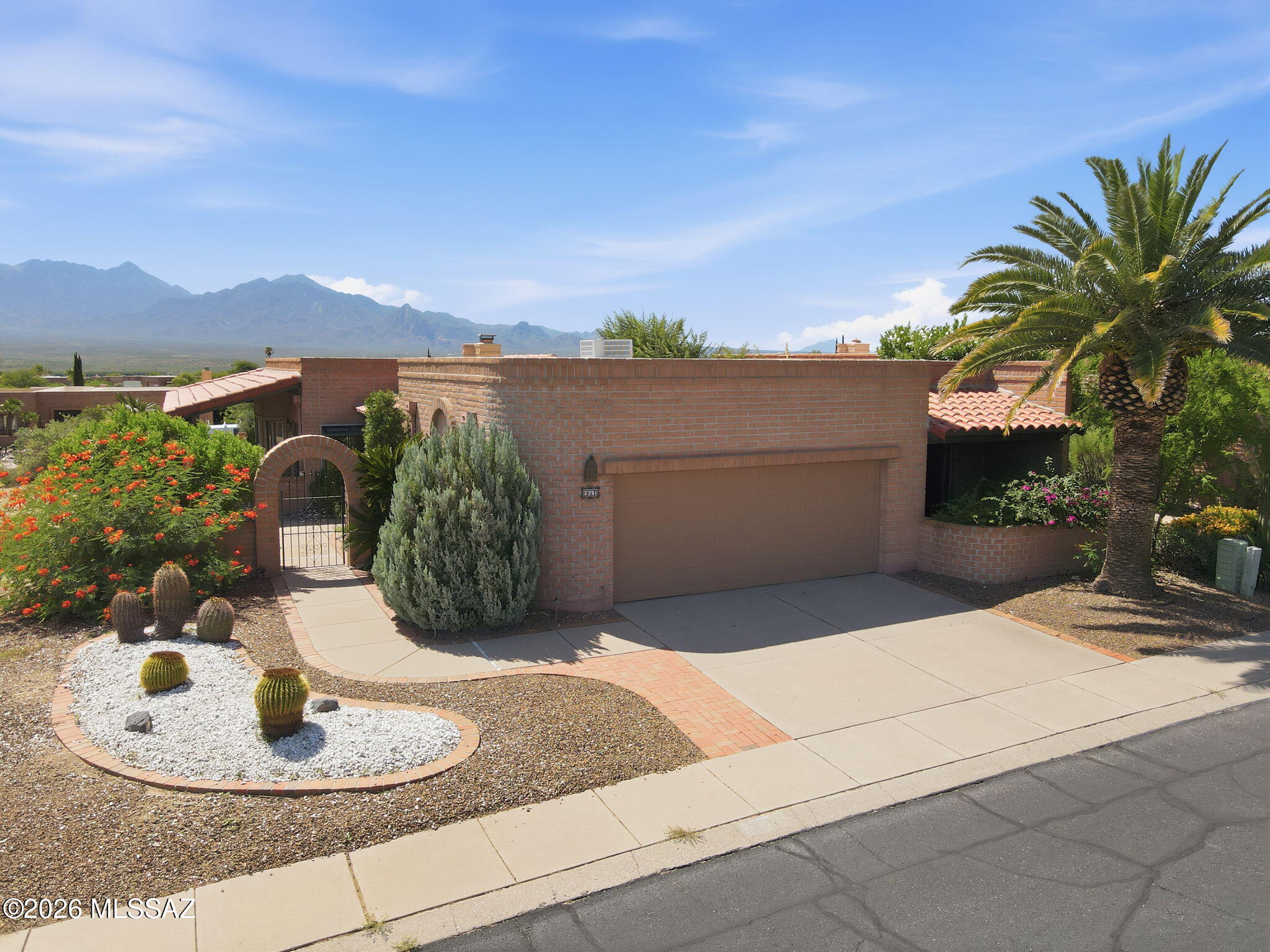Enjoy the best of Arizona living in this gorgeous single story home located in the well-maintained, desirable 55+ community of Canoa Estates. Set on a corner lot, this home offers beautiful mountain views from inside and outside. Inside, large glass sliding doors bring the mountain views into the living room, dining area, and primary bedroom. Spacious living room features a corner beehive fireplace and a convenient butler's pantry with cabinets, adding warmth and character to the home. The kitchen includes lots of cabinets,counter seating, and a dining nook with extra cabinets and sliding doors to the side patio area.  Recent updates include a new AC/heat pump, providing added comfort and peace of mind. A versatile den near the front entrance can be used as an office, studio, workout room, or additional guest space. Many outdoor spaces, including a wrap-around covered patio that is perfect for relaxing, entertaining or just taking in THOSE VIEWS. The enclosed front entryway and courtyard provide a private welcome area, while the second bedroom offers its own private front patio. Extended garage with built-in storage cabinets, workshop, storage closet and utility sink. Residents can enjoy access to 13 Green Valley Recreation community centers, offering pools, fitness facilities, pickleball, tennis and sports courts, clubs, classes, and a wide variety of activities. With mountain views, flexible living spaces, ample storage, generous patios, and a great location, you'll love living here!