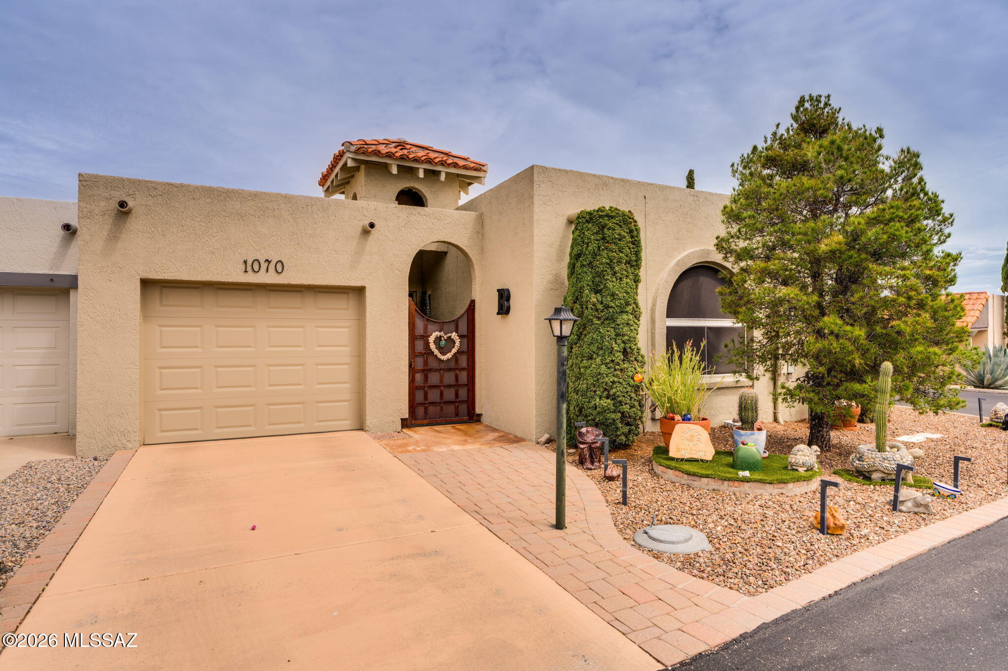 A beautifully updated end unit home that reflects years of loving care. This home has been transformed into an open-concept design, w/ modern finishes and plenty of planned storage! At the heart of the home is a beautifully designed kitchen, featuring stainless appliances, deep drawers, abundant cabinetry w/ convenient roll-outs. That same attention to organization continues into the pantry, garage and thru-out the entire home. A distinctive/unique iron entry gate and door create a beautiful first impression, while natural light and MTN views from many windows add to the feeling of openness. A screened-in patio offers an extension of the living space to enjoy Arizona's weather. Outside offers artificial grass & landscaping, creating another space to enjoy thru-out the year. Just Lovely!!