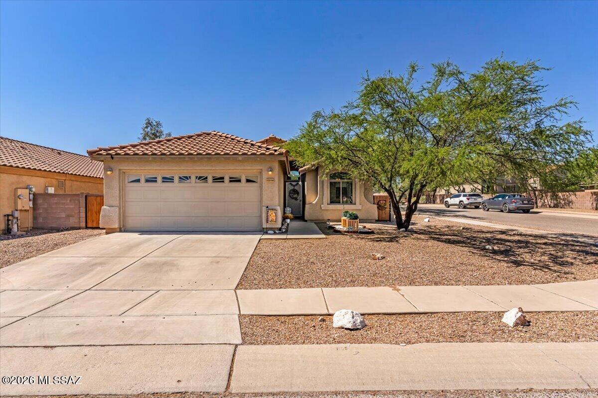 You can feel the pride of ownership in this well-maintained corner lot home. The open-concept layout is filled with natural light, luxury vinyl plank flooring flowing seamlessly throughout. The kitchen serves as the heart of the home, featuring quartz countertops, a gorgeous backsplash, painted cabinetry, stainless steel appliances ideal for everyday living and gathering. A split-bedroom floor plan offers added privacy and flexibility. Thoughtful updates include a newer roof (2023), water heater (2026), whole home filtration system (2026) and reverse osmosis system (2026). Enjoy being just moments from a neighborhood park and playground, with convenient access to I-10, Houghton Town Center, dining, medical facilities, and Mica Mountain High School.  Located in the Vail School District.
