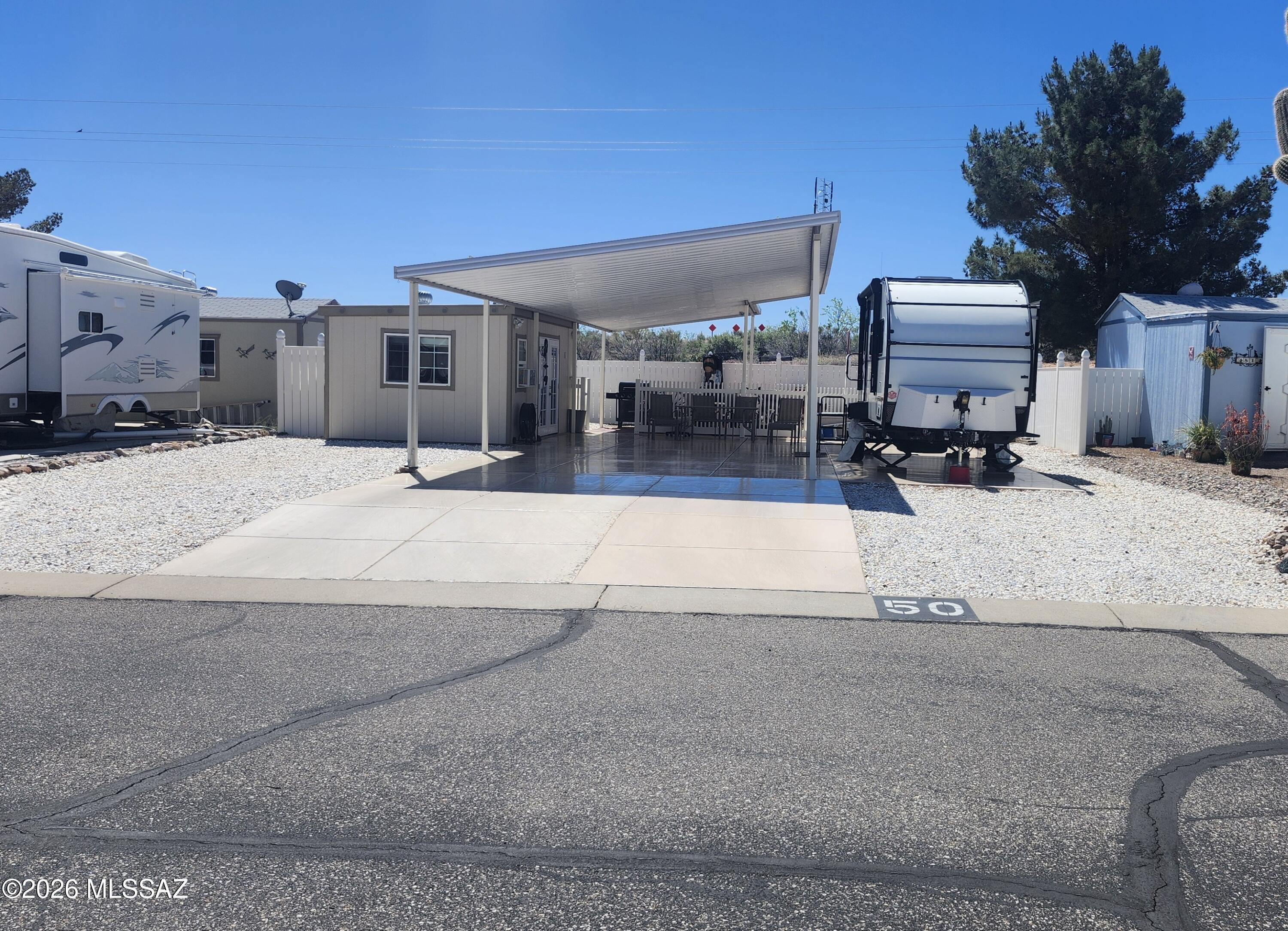 This 3500 sq ft TV lot sets nesttled in the 55+ gated community of the Cochise Terrace Subdivision. Better known as the LOA at Cochise Terrace you'll find an awning covering a concrete pad patio. There's a concrete pad for the rig and on top of all that, you can  enjoy your air conditioned she shed/man cave that aslo contains a washer and dryer. No you can't have the refrigerator.