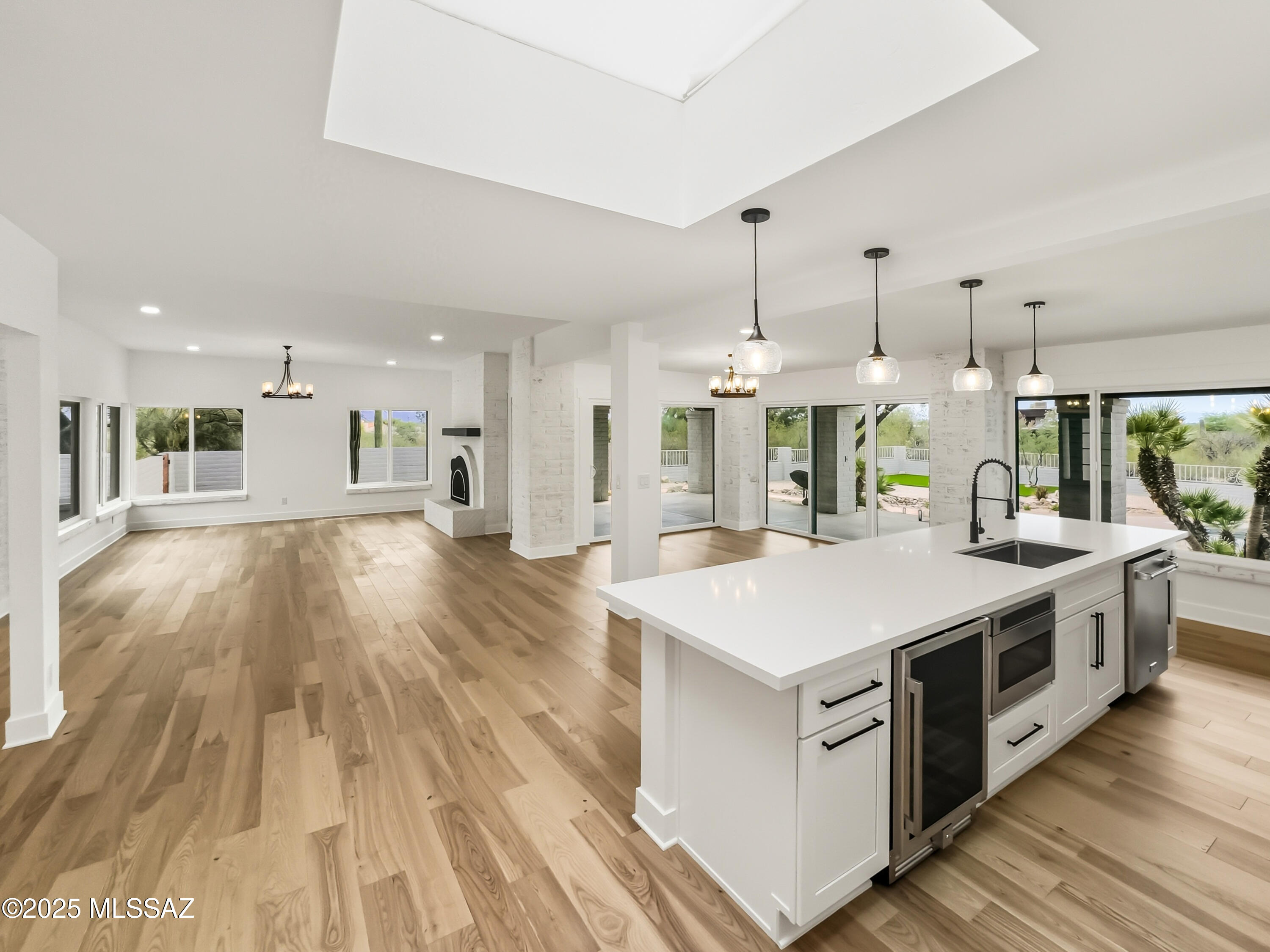 Completely reimagined with exceptional craftsmanship and meticulous attention to detail, this stunning residence sits on a 0.91-acre lot in the highly desirable NE Foothills near Canyon Ranch. Designed for both luxury and livability, the open-concept floor plan showcases solid wood flooring, designer lighting, and a chef-inspired kitchen featuring an oversized island. Perfect for entertaining and everyday living. Spa-worthy bathrooms offer refined finishes, a soaking tub, expansive walk-in showers, and elegant tile work. Each generously sized bedroom includes a walk-in closet, providing abundant storage. Step outside to your own resort-style retreat, where panoramic mountain and city views set the stage for relaxation. The backyard boasts a covered patio, spa with cascading water feature.. and a dedicated play area, ideal for Arizona living at its finest and Owned Solar-Owner/Agent