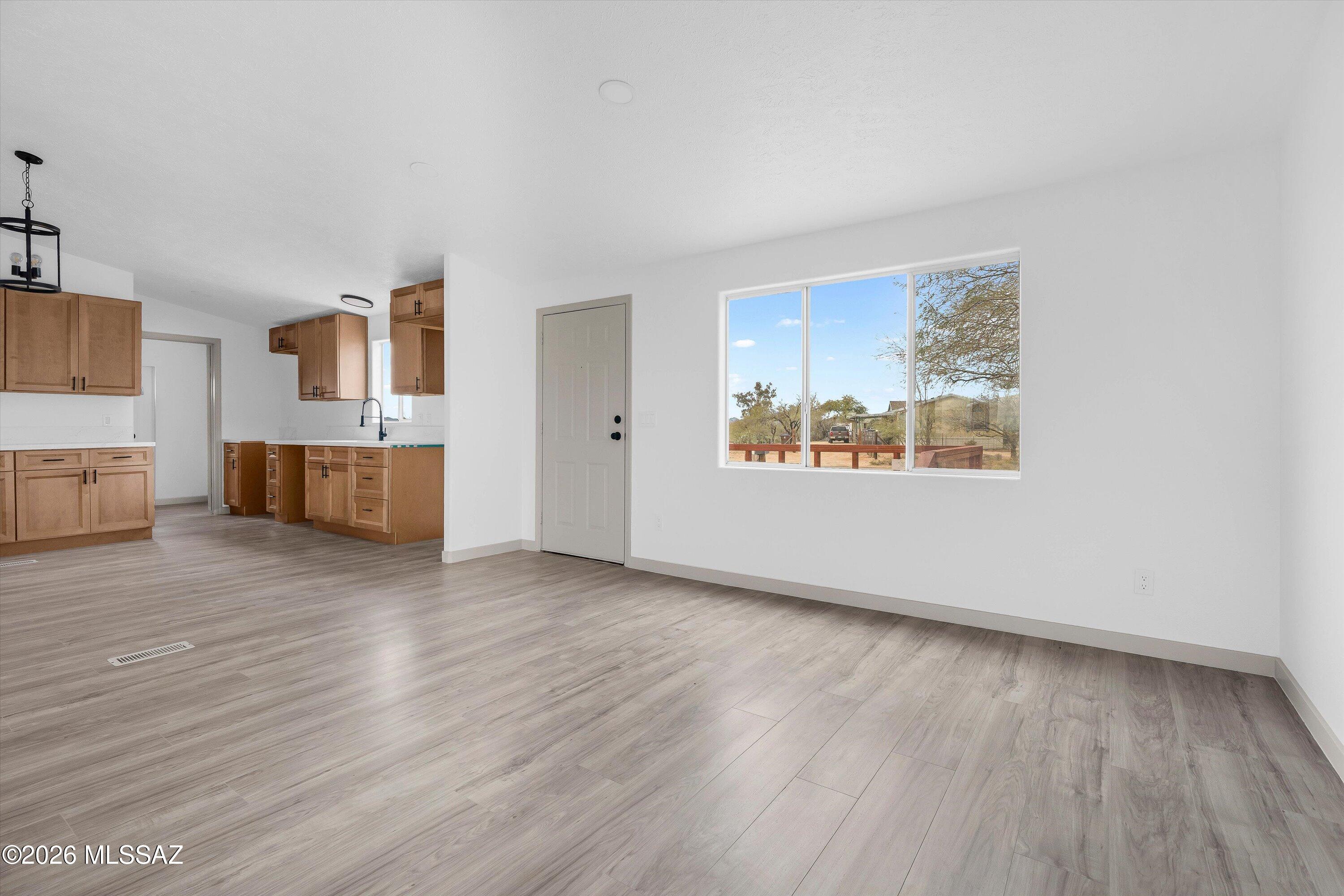 Turnkey income opportunity with both GUEST HOUSE AND OWNED SOLAR! FHA/VA/CASH OFFERS WELCOME!  This beautifully remodeled 3-Bed / 2-Bath home comes with a fully remodeled 1-Bed / 1-Bath guest house with the potential to rent for $700 per month.  Whether multi-generational living, or as an income investment, the guest house and owned solar presents a great opportunity.  Hidden in the Nelson/Marana area, it features great mountain views and spacious acre to make your own.  The guest house has its own space with attached carport and shed, plus a wide driveway that makes access easy for both units. NO HOA, There is plenty of room for additional parking, toys, animals, or future improvements. This is a rare opportunity to own a property that offers flexibility, privacy, and immediate income!