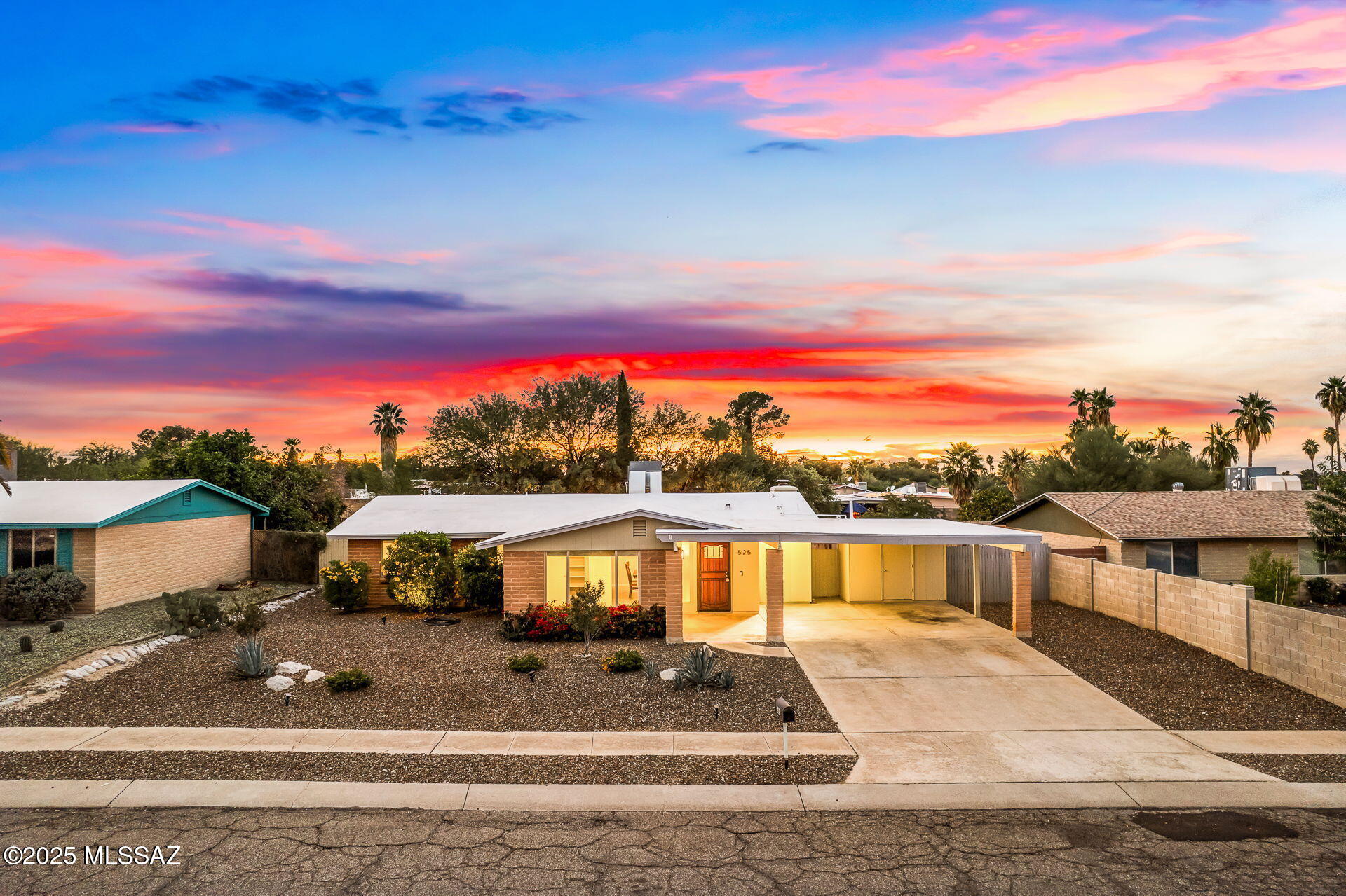 Built in 1974 and thoughtfully remodeled in 2018, this RARE 5 BED/2 BATH Eastside residence beautifully captures a mid-century feel, while incorporating modern design, quality craftsmanship, and contemporary finishes throughout. Clean lines, open living spaces, and abundant natural light create a timeless aesthetic that feels both stylish and inviting. The expansive open-concept kitchen serves as the heart of the home, showcasing a generous granite island ideal for casual dining and entertaining, crisp white cabinetry, and sleek stainless steel appliances. Custom light fixtures, recessed lighting, and a charming wood-burning fireplace flanked by floating shelves elevate the main living area, blending warmth with sophisticated design. The spacious Primary Suite is a true retreat, ... cont. offering wood-look tile flooring, a spa-inspired bathroom, double closets, and sliding glass doors with direct access to the backyard. Durable ceramic tile flooring extends throughout the common areas, while plush carpeting in the guest bedrooms provides added comfort. Ceiling fans, dual-pane windows, and strategically placed skylights enhance energy efficiency and fill the home with natural light. Outdoors, the property continues to impress with a thoughtfully designed backyard ideal for entertaining. Enjoy a fire pit, paver patio, artificial turf, flower beds, sail shades, festive string lights, and beautiful mountain views. A second rear yard offers additional flexibility, while a storage room off the carport (carport could easily be converted to an enclosed garage) and a dedicated dog run add convenience and function. A double gated side yard offers additional parking for trucks, trailers, and toys.  Recent improvements include a recoated roof (2024), new water heater (2024), and HVAC system (2018), providing added peace of mind. With its rare 5-bedroom layout, mid-century character, modern amenities, and extensive upgrades, this turnkey home offers exceptional versatility and comfort. Don't miss the opportunity to own this distinctive contemporary retreat. No HOA.