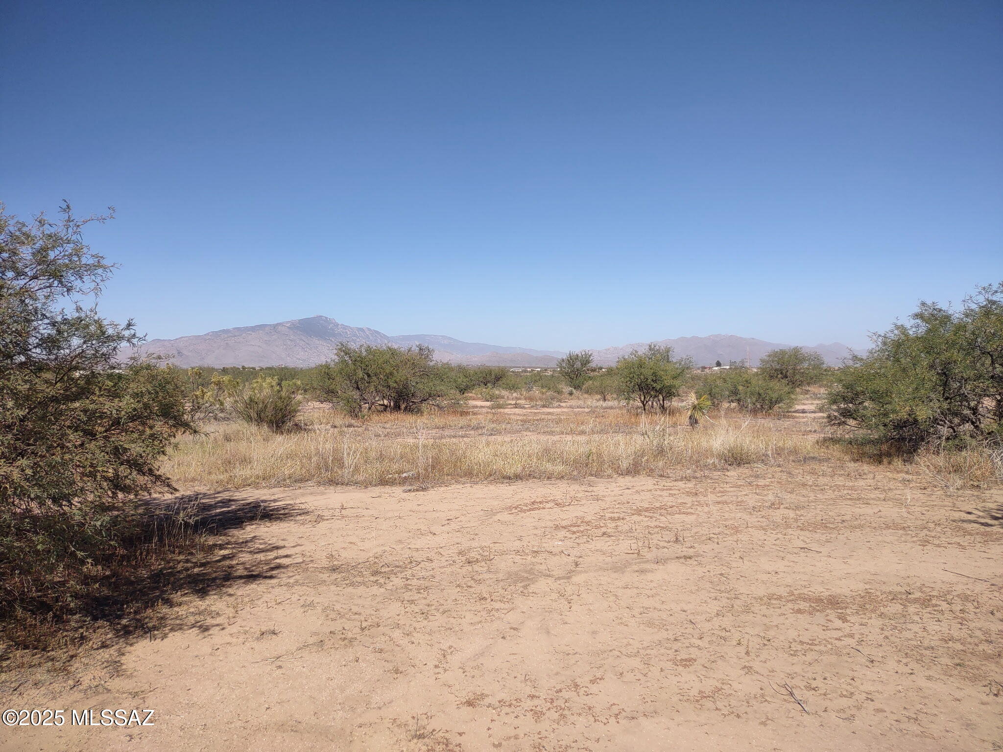 Recently surveyed 11 acre lot available in Mescal area read for your forever home. Utilities available including water from private water company. Lot offers beautiful views and privacy but easy access to I10 for shopping and other services. Relatively flat parcel for building site and mature mesquite trees for privacy. All corners are staked with red survey flags and this parcel can be accessed from Tequila Trail. Buyer to do all due diligence regarding utilities. Parcel was recently split  and will have its own parcel number at closing. Taxes are currently for parcel prior to split.