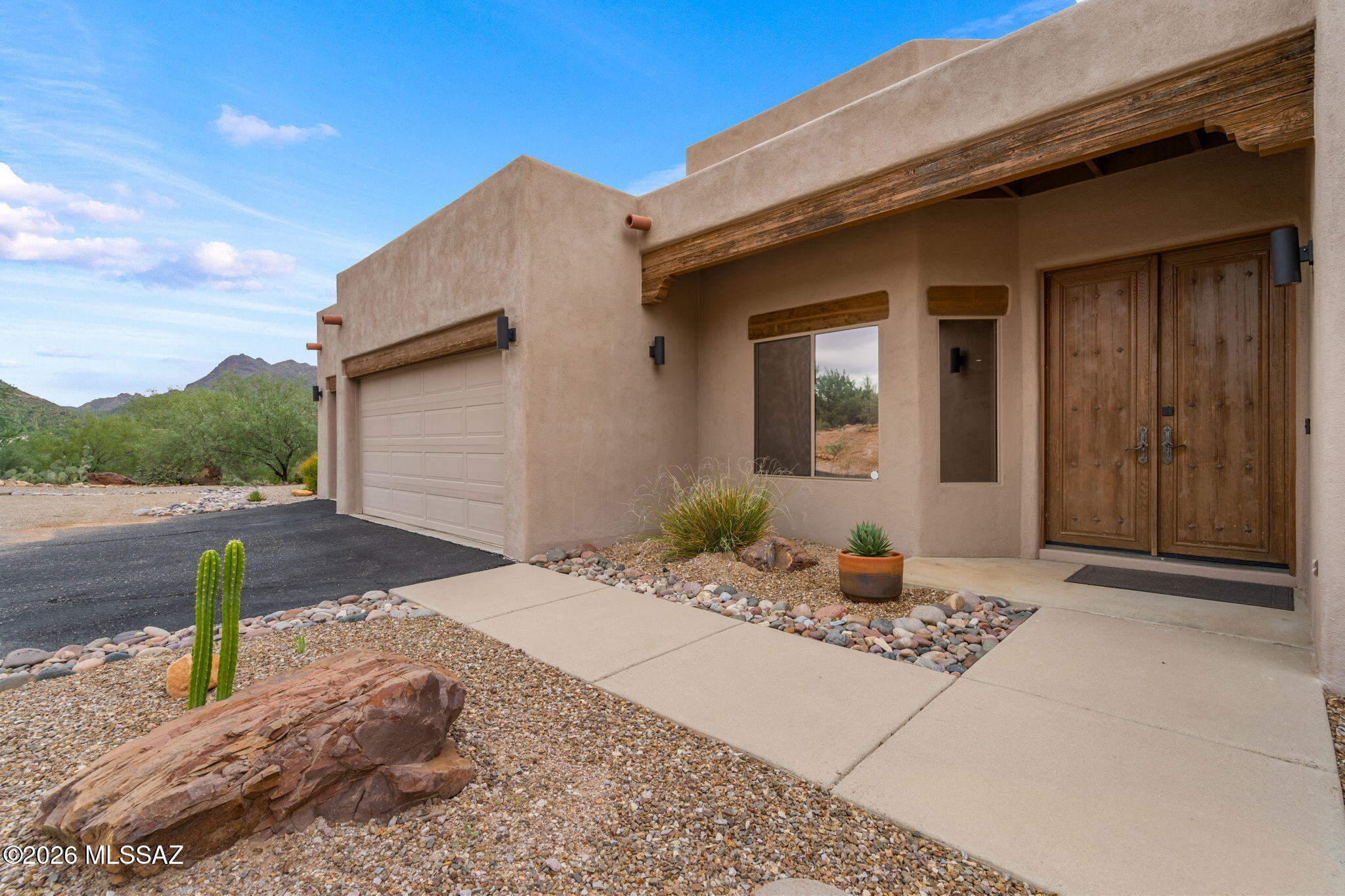 Perched on a serene hillside within an exclusive gated community, this gorgeous 4-bedroom, 2.5-bathroom estate offers ultimate privacy on over 3 pristine acres. The home boasts a thoughtfully designed split-floor plan featuring expansive living spaces, abundant storage, and modern, updated finishes throughout. Large, strategically placed windows capture breathtaking 360-degree panoramic views, while low-maintenance luxury defines the interior with ceiling fans and cozy carpeting restricted to the bedrooms. The owner's suite serves as a private retreat, complete with an elegant bay window, direct outdoor access, and a spa-like en-suite bath featuring dual vanities, a massive walk-in shower, and a generous walk-in closet. Outside, the oversized covered patio flows into a beautifully ---> landscaped yard designed for entertaining, complete with high-quality pavers, a grill, artificial turf, and minimal upkeep. A spacious 3-car garage with an attached workroom completes this exceptional property. Come experience a lifestyle of pure peace and tranquility!