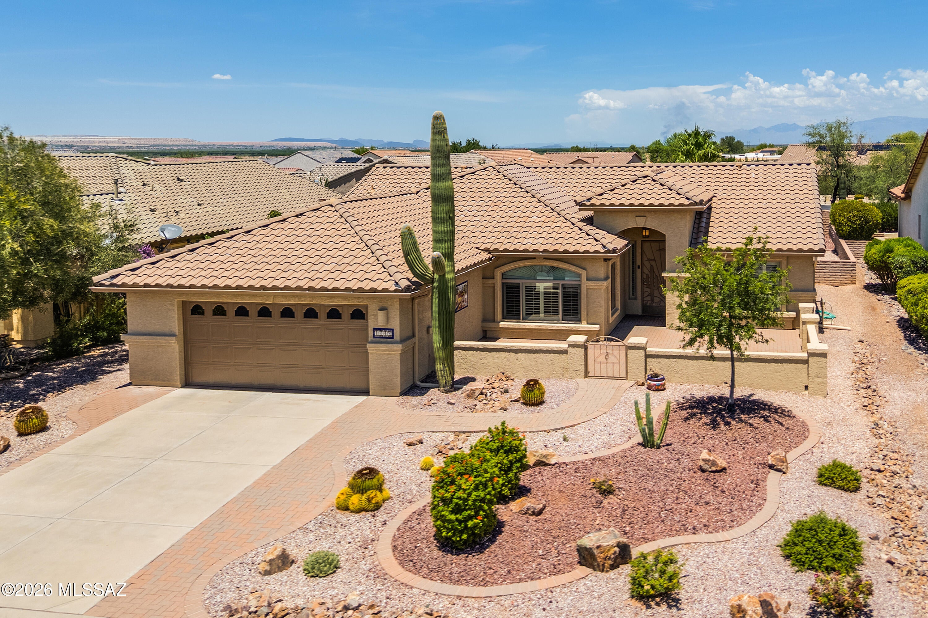 Beautiful curb appeal, thoughtful builder expansions, and quality updates -- including a new roof and HVAC system installed in 2024 -- make this move-in ready expanded Laredo model in Quail Creek an EXCEPTIONAL VALUE at under $450K. Offering 1,963 sq.ft., 2 BR, 2 BA, and Den, this home welcomes you with a majestic saguaro, attractive front paver courtyard, and inviting entry. Inside, the foyer opens to a spacious great room featuring built-in niches, a cozy gas fireplace, plantation shutters throughout, and an open floor plan ideal for everyday living and entertaining. The upgraded kitchen boasts granite counters, tile backsplash, 41'' upper cabinets, island, breakfast bar w/ pendant lighting, newer appliances, and an adjacent dining area expanded an additional 4'. Popular builder expansions also include a 2' extension to the Den, Guest Bedroom, and Guest Bath, providing added comfort and flexibility. The owner's suite features a bay window, dual vanity bath, walk-in custom tile shower, and generous walk-in closet. 
 
Ceramic tile floors flow throughout the home, with carpet only in the guest bedroom. Double doors allow the Den to serve as a private office or optional third sleeping room. Additional highlights include a spacious laundry room with utility sink and abundant storage, plus an extended-length 2-car garage complete with built-in storage cabinets and overhead storage. The private backyard is beautifully landscaped with mature citrus trees and desert plantings,  anew irrigation system, and offers an end-to-end covered patio, extended paver patio, and relaxing hot tub. Major updates include new exterior paint in 2026, and a new roof and HVAC system in 2024, making this home truly move-in ready while allowing you to enjoy the outstanding Quail Creek lifestyle.