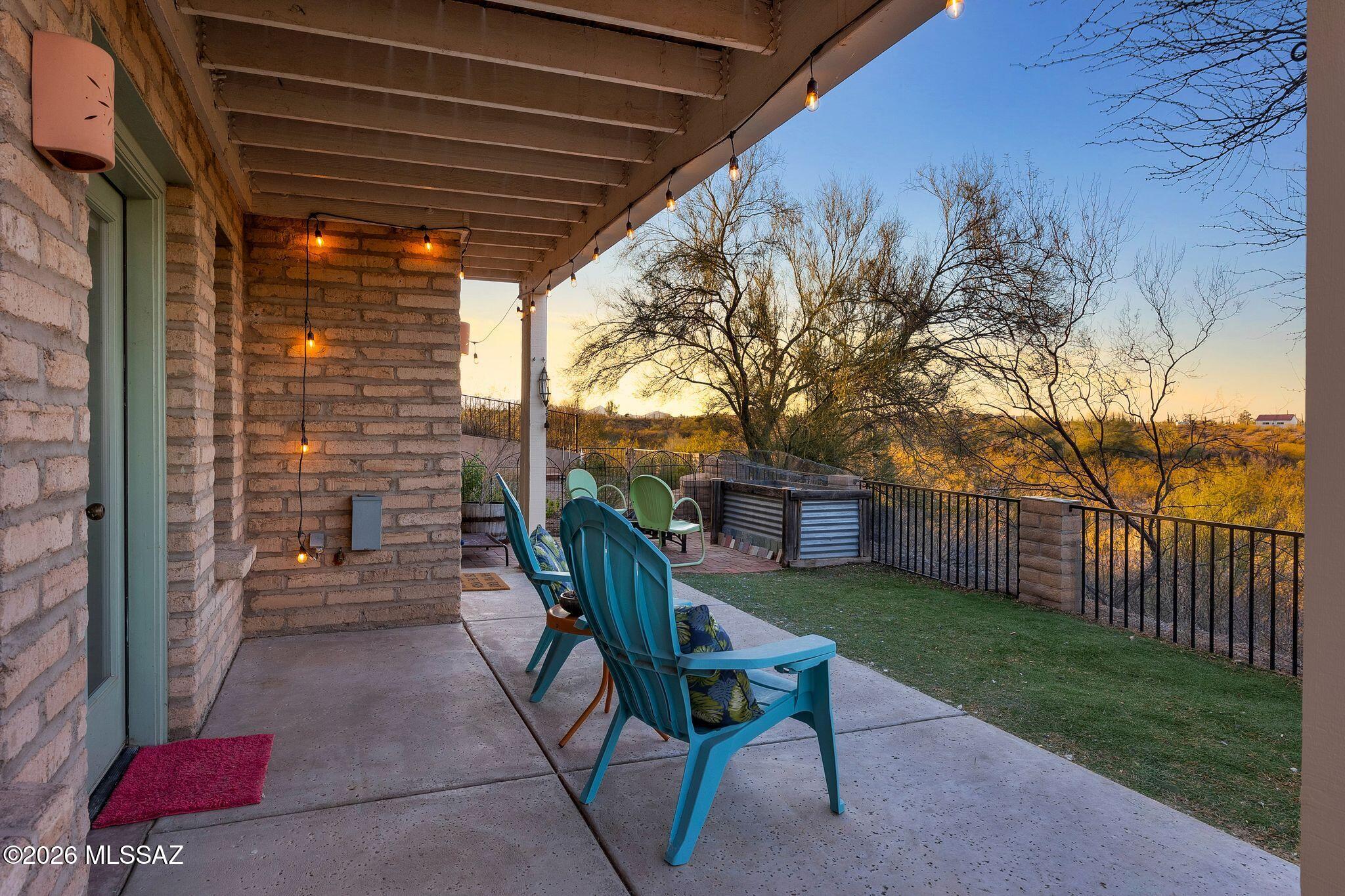 Experience the ultimate sustainable lifestyle in one of Milagro's most exclusive & comfortable floorplans. This architectural gem features 14 inch thick modern adobe block walls, owned solar with battery backup & sweeping, unobstructed views of the Catalina Mtns from your private upper balcony. Perfectly designed for remote executives, seasonal residents or families seeking a vibrant connected neighborhood without the hassle of intense property maintenance. This versatile 4 bedroom 2 bath layout features unmatched space & privacy. The generous square footage easily transforms to fit your lifestyle needs. Ideal for configuring as an expansive multigenerational residence, a dedicated home with His&Her private offices or a guest/fitness suite. Step outside into Milagro's lush eco-conscious intentional community - a true paradise of shared values and harmonious desert living. Enjoy a walkable food forest, a 35 acre desert nature preserve, a solar heated swimming pool & dynamic common house featuring a well appointed community kitchen, play & meeting spaces & library. Just 15 minutes from the University of Arizona and Downtown Tucson, this turnkey residence is for the discerning homeowner seeking beauty, community, sustainable living & access to nature.