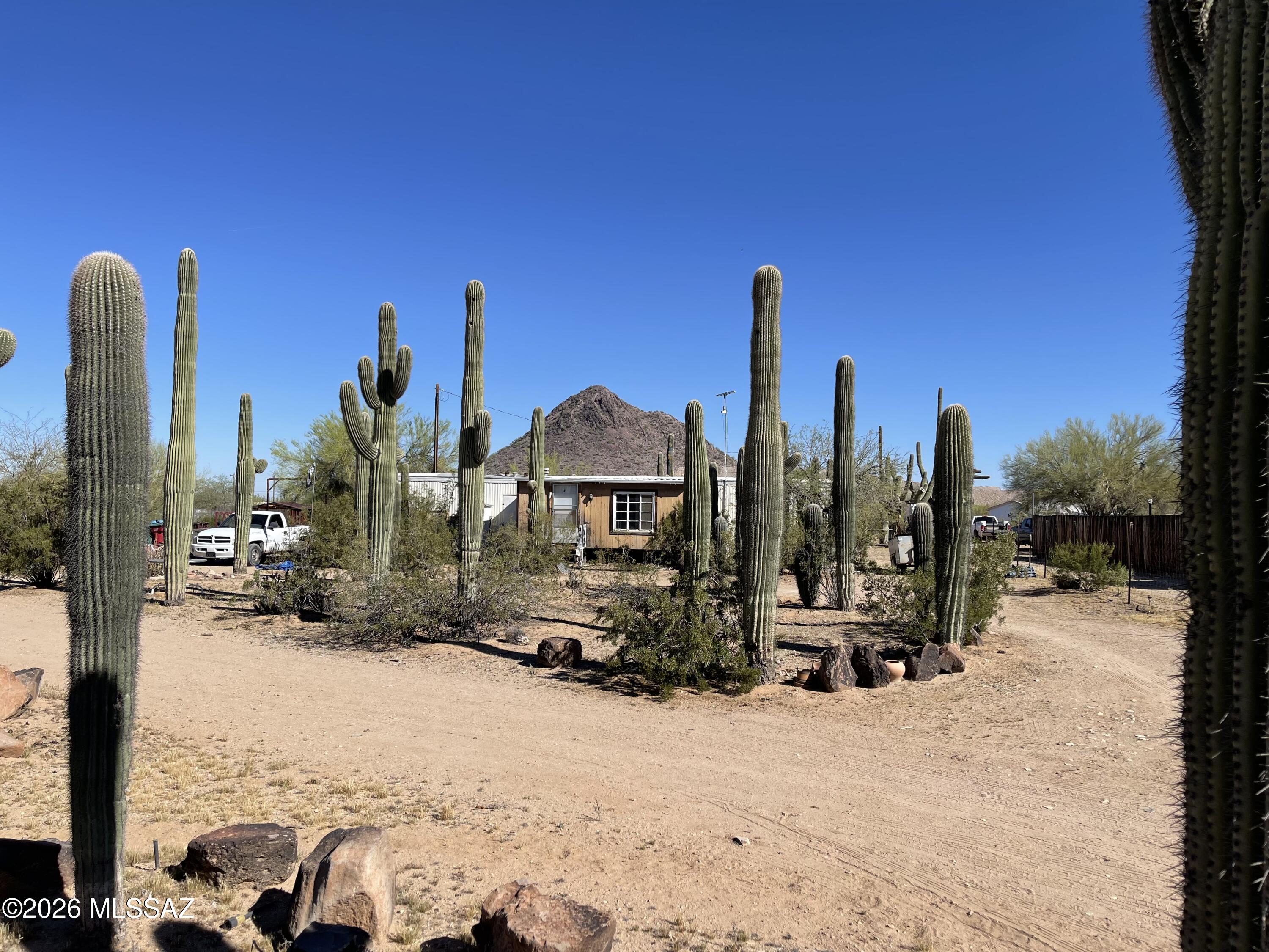 Fix-up Mobile Home on an 1.1 acre lot. Home is currently a 1 bedroom but can be converted back to a 2 bedroom. 4 sheds convey. Pima County GR-1 zoning. Short distance to Sendero Esperanza Trail in Saguaro National Park West.