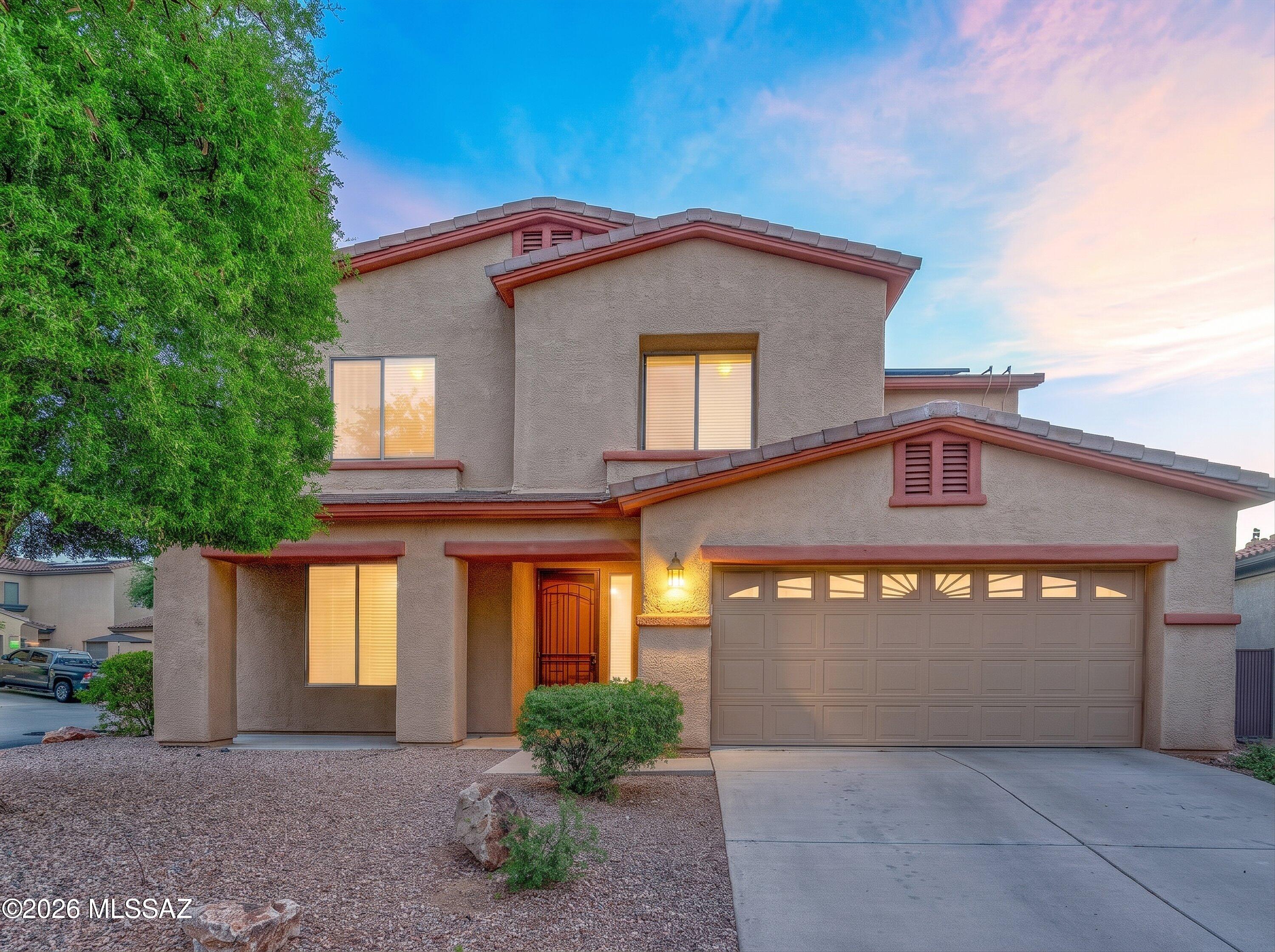 Welcome to Encanto Del Lago! This stunning home is located within a gated community beside Sahuarita Lake, perfect for long walks along the water. 4 bedrooms, 3 full bathrooms, a den, and a loft make this home spacious and luxurious. Freshly painted  first floor living areas and loft! This property features a corner lot, multiple fruit trees, a large backyard with real grass, mature plants, a stunning patio, a movie screen, and a built in grill and bar. All backyard plants are on an irrigation system, so sit back and enjoy! The garage features 3 spaces (tandem) with built in cabinets for extra storage. There is a water softener system included with the home as well as a reverse osmosis system that makes drinkable water direct from the kitchen sink or refrigerator. Truly a must see home