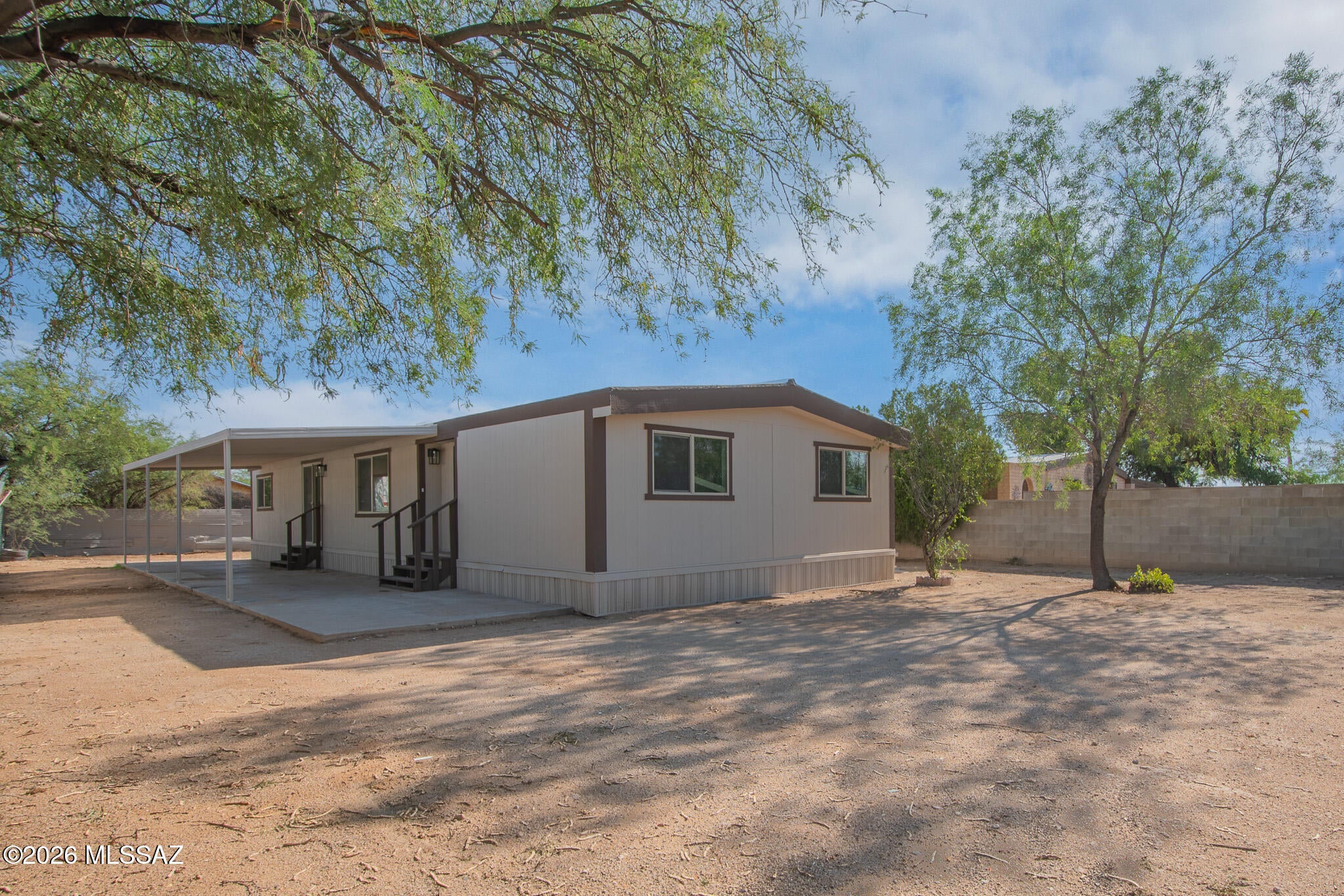 Beautifully remodeled 3 bedroom, 2 bathroom manufactured home offering a fresh modern feel throughout! Step inside to a bright and spacious floor plan featuring wood look flooring, fresh finishes, and abundant natural light. The updated kitchen features white cabinetry, sleek countertops, stainless steel appliances, and modern black accents. Generous living and dining spaces provide plenty of room to gather and entertain. Outside, enjoy an expansive covered patio perfect for relaxing and enjoying Arizona living. Stylish, refreshed, and move in ready, this home is a must see!