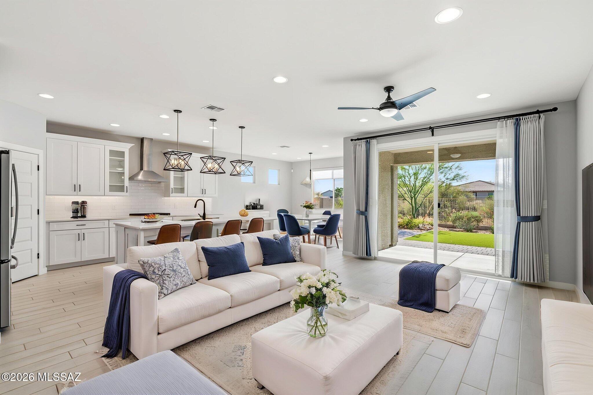 Step into this beautifully designed 2022 Meritage-built home featuring the sought-after Classic White Design Collection. Thoughtfully crafted for modern living, the open-concept layout seamlessly connects the kitchen, dining, and great room--perfect for everyday living and effortless entertaining. The spacious kitchen island anchors the heart of the home, offering both function and style. A versatile flex space provides endless possibilities--ideal for a home office, creative studio, or additional lounge area. The primary suite is a true retreat, complete with an expansive walk-in closet designed for optimal organization.Enjoy indoor-outdoor living with a professionally landscaped backyard that offers added privacy and a peaceful setting to relax or entertain. Located within the gated community of Saguaros Viejos, this home also showcases energy-efficient construction designed for comfort, sustainability, and long-term savings.