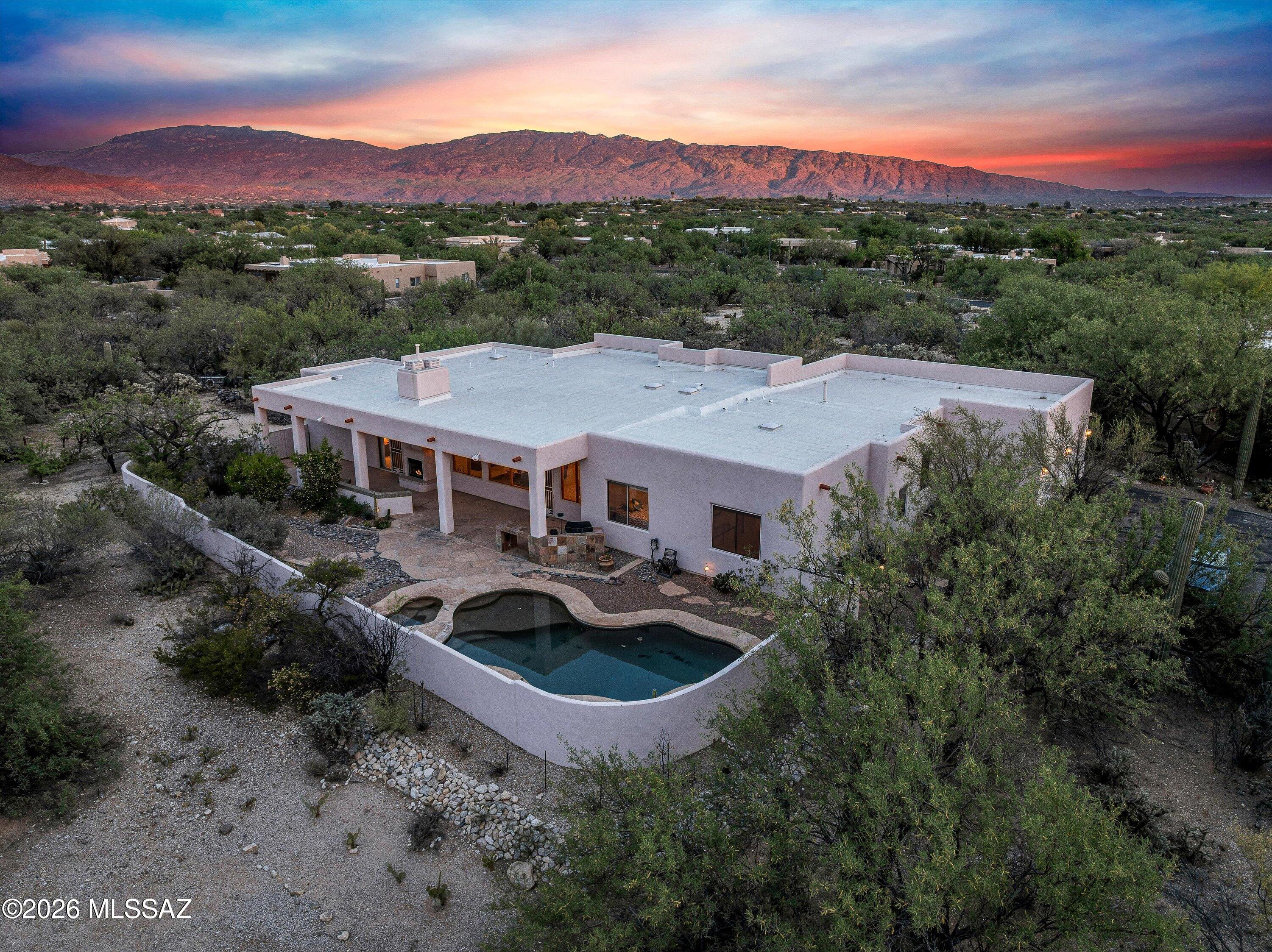 Motivated seller!  PRICED TO SELL as-is.  Gorgeous Catalina MOUNTAIN VIEWS from north facing backyard, great room, kitchen and 3 of the 4 bedrooms, including primary. Front living room with Rincon Mountain Views and private patio. Southwest Style home features wood beams in great room. Large kitchen with abundant counters & maple cabinets. Huge master bath with walk-in shower and separate tub. FOUR CAR tandem garage with built-in storage and 2nd fridge. Outdoor living with covered patio, built-in BBQ & bar, fireplace, pebble-tec pool & spa on 1.08 acre lot. Split floorplan: 3 beds W, primary NE. Separate Living Room, Formal Dining, AND extra room off primary (office, gym, nursery) Get ready to spread out, entertain, and enjoy the best of Tucson living. Welcome Home!