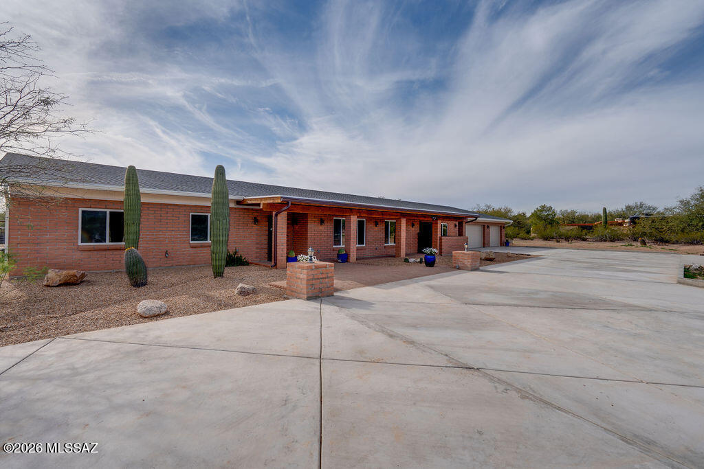 Set within Catalina Ranch Estates, this newly renovated equestrian property spans 3.4+ usable acres with sweeping views of the Rincon and Catalina mountain ranges. The setting offers privacy, open space, and convenient access to Mount Lemmon, Saguaro National Park, and Agua Caliente Wash.

The residence has been expanded to a 6 bedroom, 5 bathroom layout, including four suites with private access. Main living areas feature an open modern kitchen, oversized butler's pantry, large laundry room with extensive cabinetry and counter space, updated bathrooms, and fully updated systems, including two Trane HVAC units with new ductwork. A full-length covered rear patio stretches across the back of the home, extending daily living outdoors, with direct access from the primary suite. Thoughtfully updated to preserve the character of the original homestead, a former casita was integrated into the main residence, creating additional connected living space. Complete with equestrian infrastructure, featuring well kept facilities with stalls, feed room, wash rack, and arena. The rear property is fully fenced with an aesthetically pleasing 6ft no climb iron pipe and t-post perimeter.