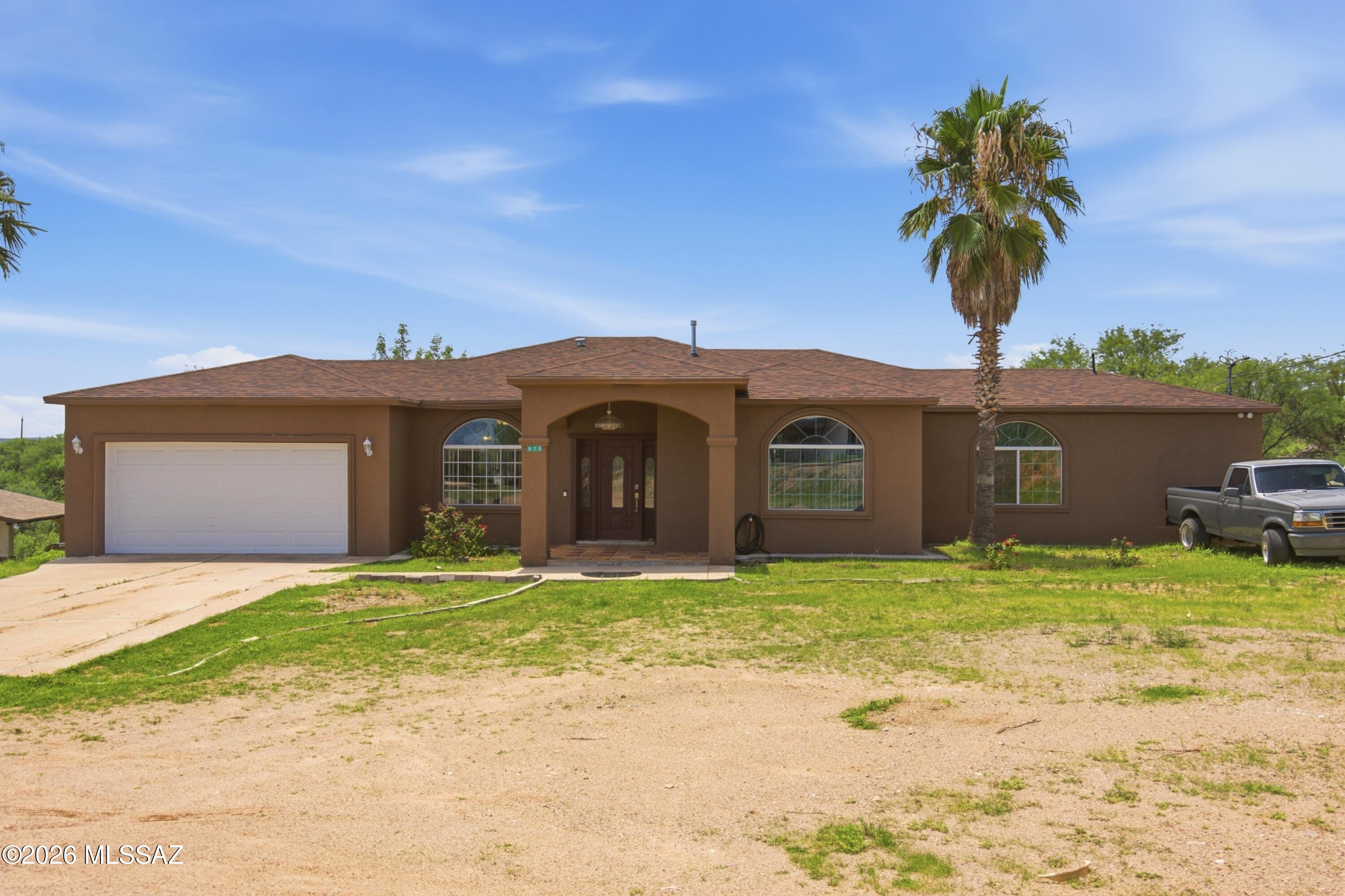 Discover the space, privacy, and peaceful desert setting of this charming Rio Rico home. Situated on approximately 0.75 acres, this spacious 3 bedroom, 3 bathroom residence offers approximately 2,539 sq. ft. of comfortable living space. The single story layout features tile and carpet flooring, a 2 car garage, and a functional floor plan with plenty of room for everyday living and entertaining. The generous lot provides ample space to enjoy Arizona's beautiful landscape, outdoor living, and quiet surroundings. This home offers a relaxed Southern Arizona lifestyle while providing convenient access to nearby shopping, dining, schools, and outdoor recreation. Come check out this wonderful home!!