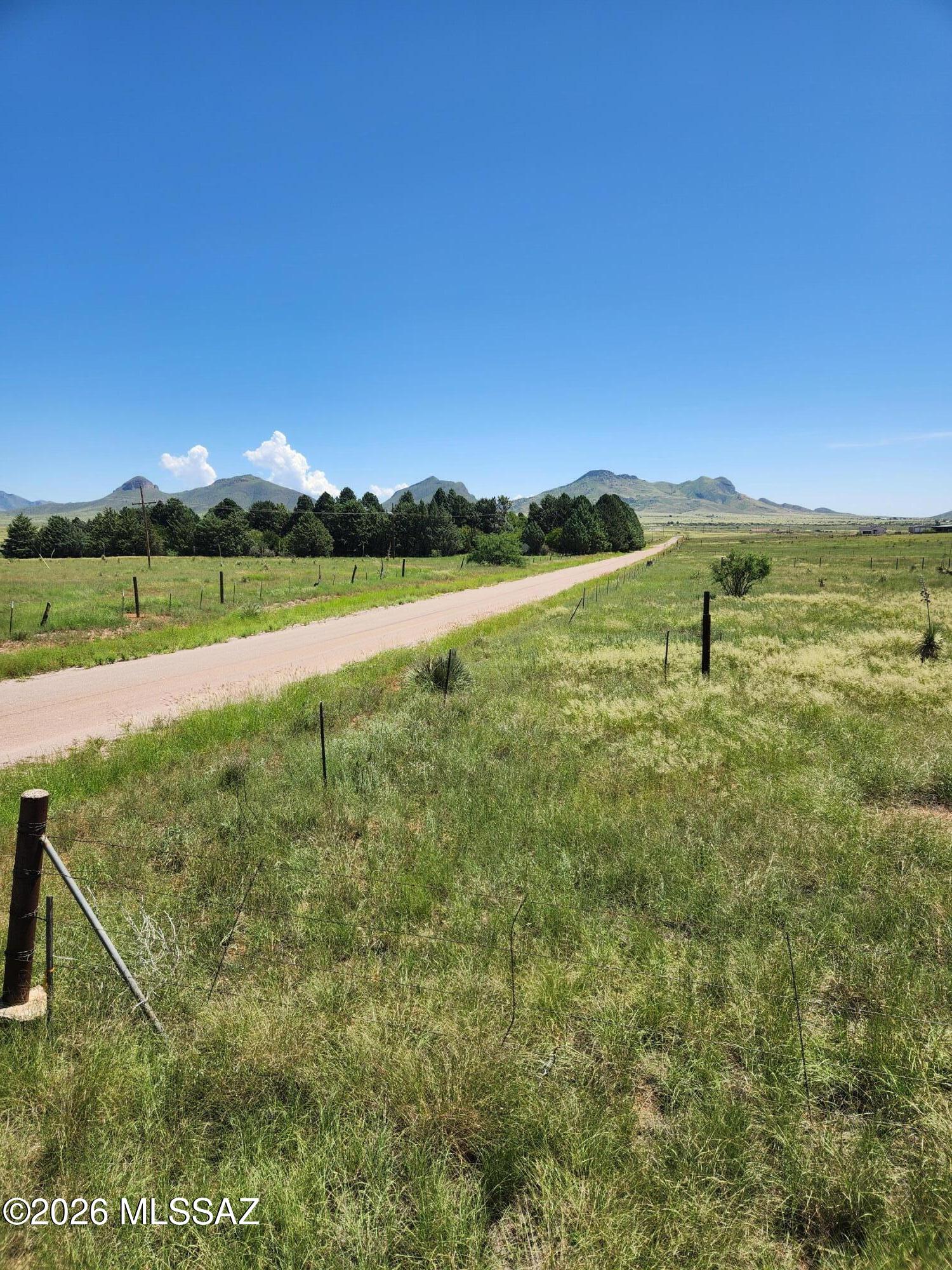 Nestled on a level corner lot in the highly sought-after Sonoita/Elgin wine country this exceptional parcel invites you to build your dream home amid rolling lush green and golden grasses and breathtaking panoramic mountain views that stretch endlessly across the horizon.  Fully fenced with convenient access from a paved road, it features a capped well and sits safely outside any flood zone, offering pure peace of mind in a cooler rural climate where crisp fresh air and serene open spaces create the ultimate backdrop for your Arizona lifestyle.  Fantastic views of the Mustang Mountains!  Call to see this ideal parcel today!