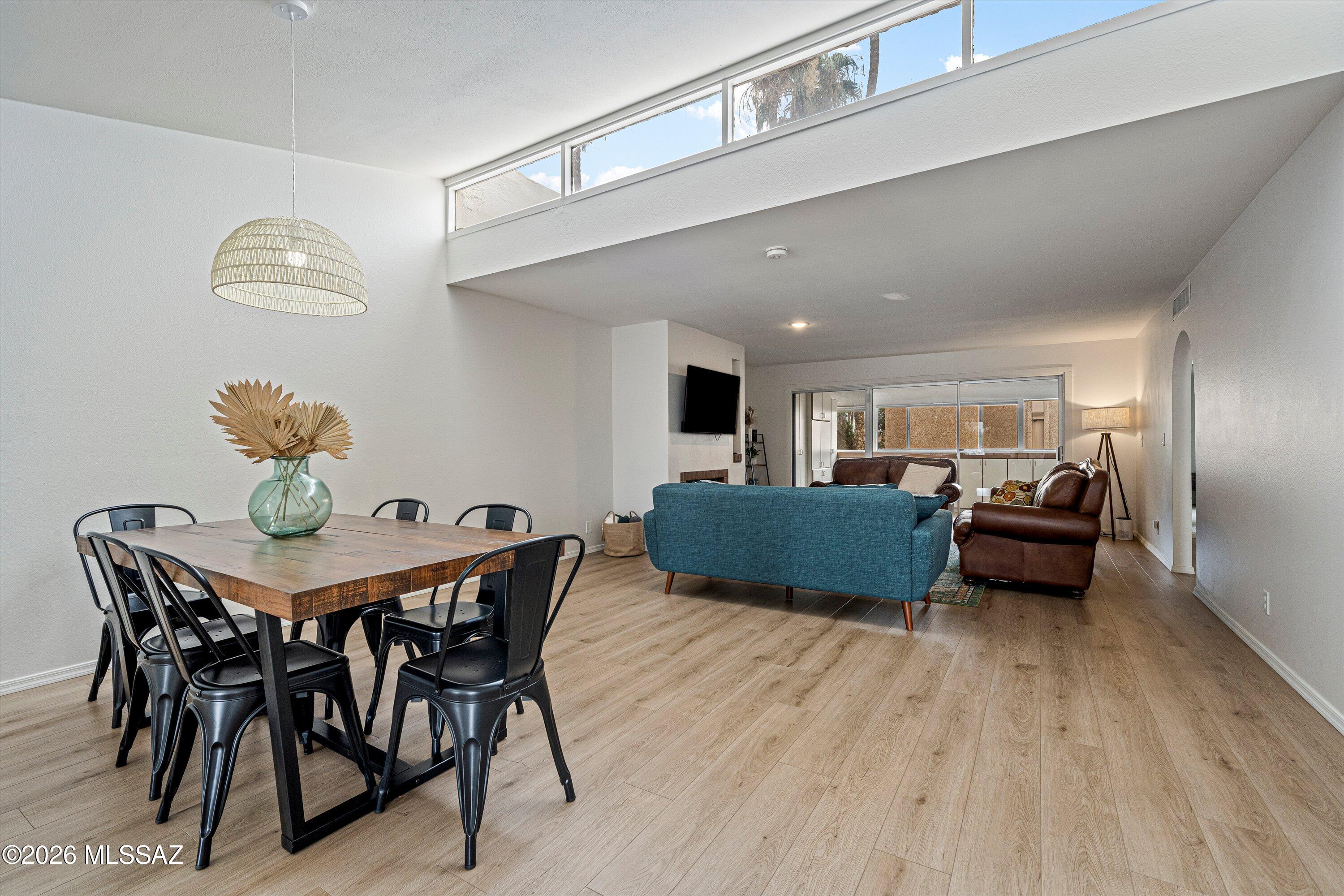 Discover an incredible value in the heart of Central Tucson! This spacious 3bed 2bath condo offers 1,712 square feet of comfortable living space & is being sold fully furnished, making it an easy option for a primary residence, Tucson getaway or investment property. Step inside to soaring vaulted ceilings, exposed wood beams, clerestory windows & a cozy fireplace that give the home warmth & architectural character. Luxury vinyl plank flooring, updated lighting & hardware create a fresh, contemporary feel, while the bonus room w/ built in cabinetry provides flexible space for an office, den or additional living area. The private primary suite features a walk-in closet & beautifully retiled bath, while the refreshed guest bath includes a newer vanity. Covered parking & a separate storage closet add everyday convenience. Enjoy a lush, established community w/ mature landscaping, pool, spa & putting green, all just minutes from the University of Arizona & Downtown Tucson. HOA approved short term & long-term rentals provide additional flexibility for future owners. Spacious, furnished & centrally located, this is a unique opportunity to own more than 1,700 square feet in Central Tucson at an approachable price point.