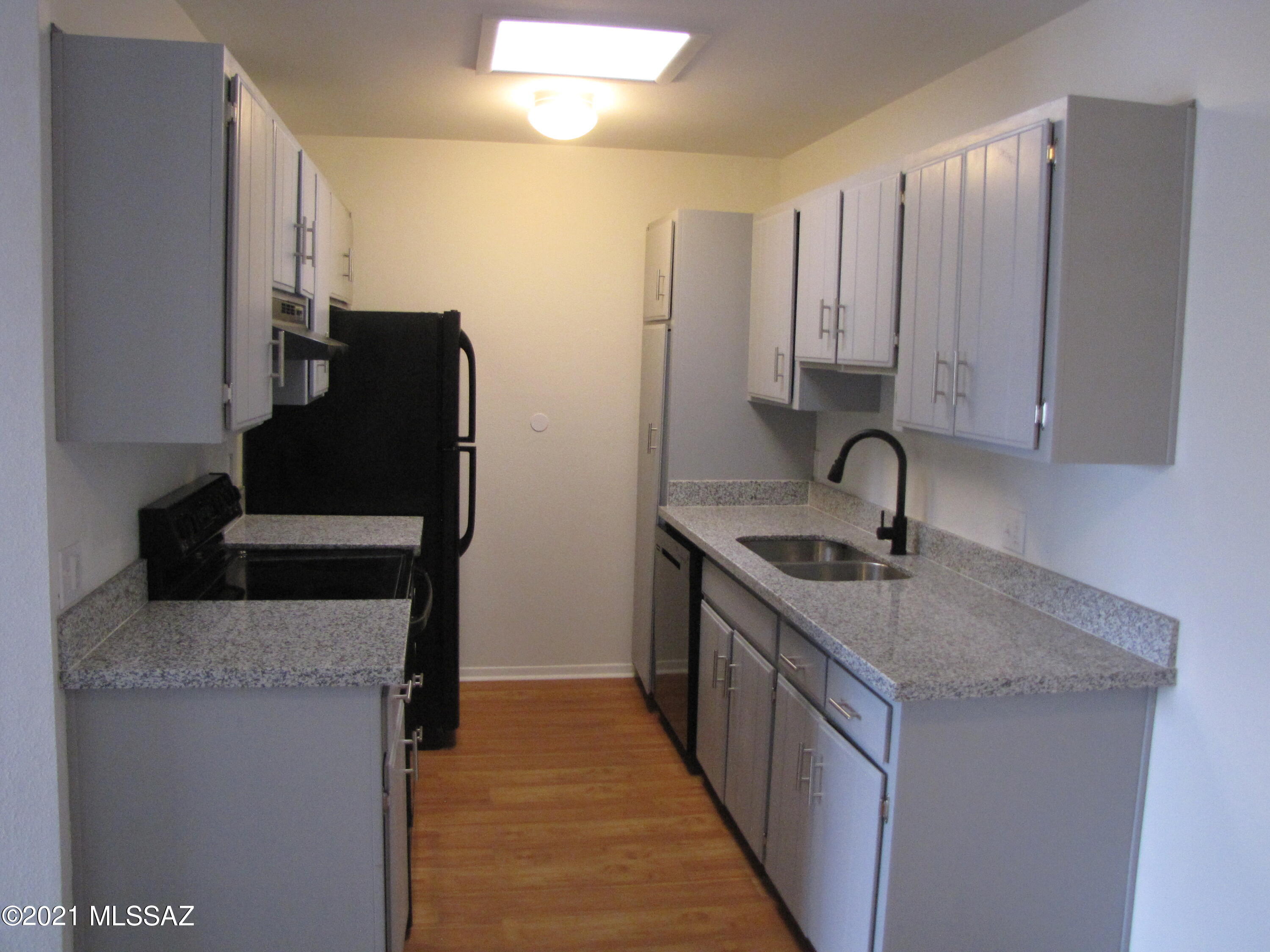Tastefully remodeled Townhouse with a Community Pool!  Spacious open floor plan.  Freah paint. Ceiling fans, window blinds & handsome engineered wood floors.  Stunning new kitchen features granite counters, under-mount sink, pantry, newer appliances & plenty of gray cabinets w/stylish hardware.  This move in ready charming home boasts 2 large bedrooms, ample closets, 2 upgraded baths with granite counters, & private balcony.  Interior laundry closet for your convenience