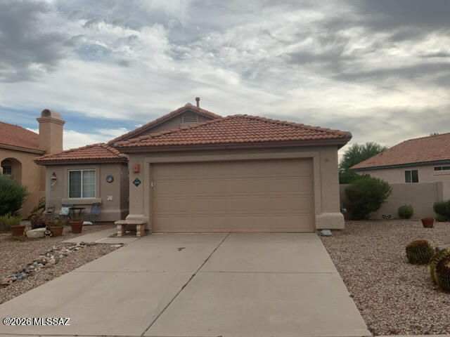 Welcome to this 3-bedroom, 2-bath home in the desirable Rancho Vistoso area of Oro Valley. Inside, you'll find a bright living and dining area with a cozy fireplace, plus a spacious kitchen with ample cabinet and counter space and a breakfast area. The primary suite features an ensuite bath with dual sinks, while two additional bedrooms offer space for guests, a home office, or hobbies. Enjoy the covered patio and low-maintenance backyard with mature landscaping. Conveniently located near shopping, dining, parks, walking and biking trails, golf, and the scenic Catalina Mountains, this home offers the opportunity to enjoy all that Oro Valley has to offer. Don't miss your chance to see it today! Buyer to verify all matters of material issue.