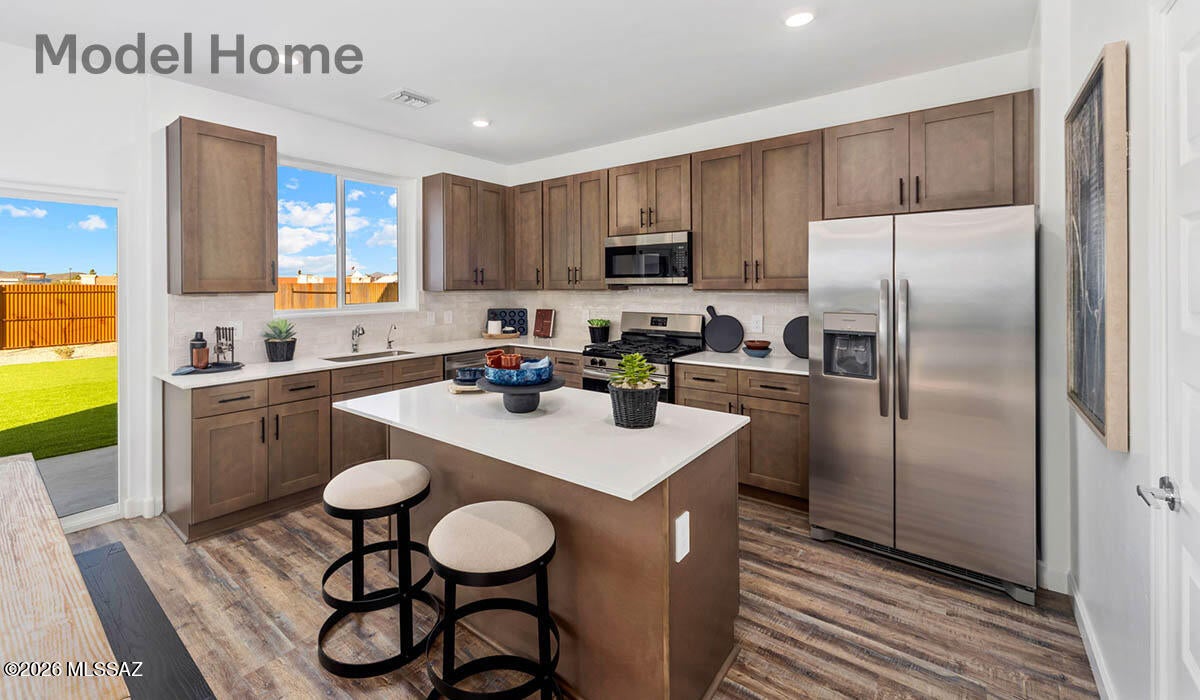 Brand new Construction in The Oasis at Rocking K by D.R. Horton Homes featuring the Gila floor plan. This spacious 2057 sq ft two story home offers 4 bedrooms, 3 full bathrooms, and a 2-car garage. The open concept main floor includes a modern kitchen overlooking the great room, perfect for entertaining. One bedroom and full bath is conveniently located on the first floor, ideal for guests or a home office. Upstairs, enjoy a generous primary suite with walk in closet, plus additional bedrooms and a versatile loft space. Energy-efficient features (Spray foam insulation), contemporary finishes and low maintenance desert landscaping complete this beautiful home.  Don't miss it! HOME TO BE BUILT.
