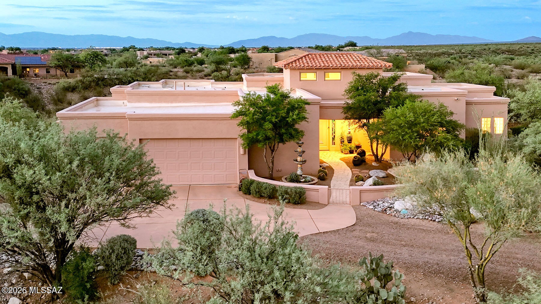 Step through the gates into a large front courtyard and you'll immediately sense this home is different. Striking architectural curb appeal sets the tone before you even reach the door, hinting at the artistry that awaits inside.

Cross the threshold into soaring ceilings and an interior filled with thoughtful, artistic touches at every turn. A wall of windows spans the back of the home, blurring the line between indoors and out and framing an unobstructed desert landscape that stretches to the sky. No homes behind you--just open desert, brilliant sunsets, and star-filled nights. This kind of privacy is rare, and it transforms everyday living into something special: dining al fresco under the stars, quiet evenings on the patio, and gatherings that feel like a retreat rather than a routine.  The heart of the home is a wide-open kitchen flowing seamlessly into the family room, where a glowing fireplace sets the mood for cozy and quiet evenings at home, and a dining nook is perfect for more intimate meals. A small kitchen patio is adjacent for gazing at the mountains during cocktail hour, or grilling under the desert sky.  A formal dining room offers a beautiful setting for larger, elegant entertaining, while a dedicated media room--already wired with built-in acoustics, sound proofing and lighting--is ready to become your private movie theater!  This room also doubles as a sound studio, or safe room.  Family movie nights here will turn into memories that last for years.  Your primary suite is spacious and tranquil and offers an extra space for a private office, reading room or simply lounging.  A guest en-suite offers privacy for long-term guests and an additional guest room can be used for guest overflow, a craft room or formal den, whatever your new lifestyle calls for.  

Two additional bedrooms offer the flexibility today's families need: room for kids to grow, space for extended family or a mother-in-law stay, or the perfect his-and-hers home offices.

This is more than a home--it's a Southern Arizona sanctuary where architecture, privacy, and desert beauty come together in perfect harmony.