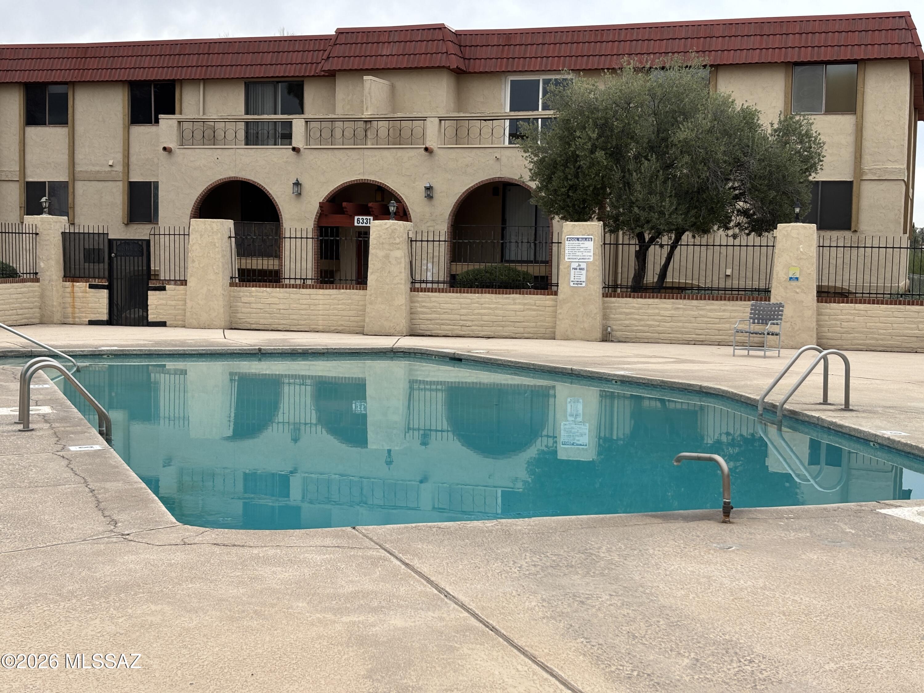 Stop renting! Own for less than you think! Gas, water, trash, building maintenance, 2 pools, and more are included in the HOA fee. This affordable 2-bed, 1-bath unit is suitable as a full-time residence, rental property, winter vacation home, and housing for your U of A student. Centrally located, this condo is close to shopping, bus line, U of A, downtown, and the I-10 freeway. The primary bedroom is light and bright, with 2 windows, a walk-in closet, and storage space. The kitchen appliances and window blinds stay. One of 2 community pools is just outside the front door of Building 9. Covered balcony overlooks a lush desert wash with sunset views. Mt views from the bedroom window. Lots of birds and wildlife. You need to see this unit!