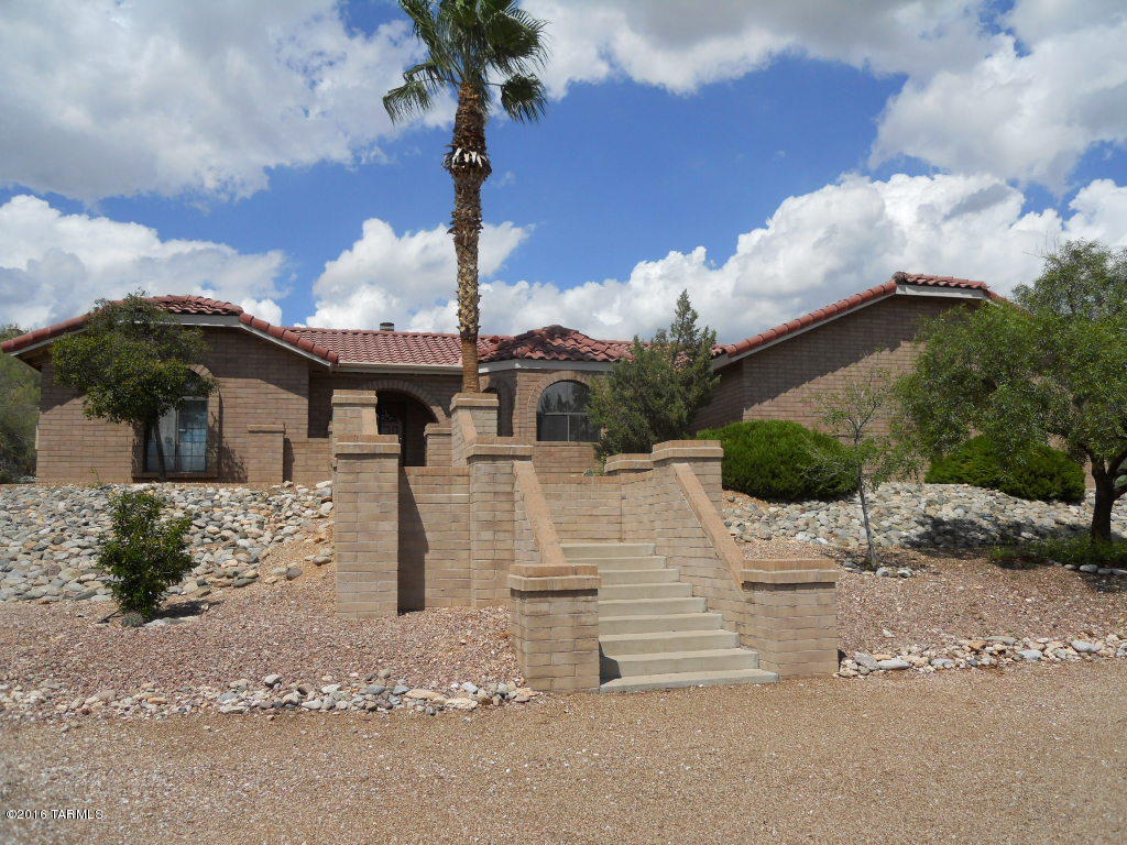Territorial Home in Tucson Foothills. Welcoming circular driveway, inviting foyer, great room, cathedral ceiling wood beams, curved archways, built-in cabinetry, wood burning fireplace and plenty of storage. 4 Bedroom/ 2 Bathroom Split Floor plan. Extended covered rear patio, private rear entry master suite with master bathroom & walk in closet. 6 Ceiling fans, security doors. Rear fenced yard backs to natural desert. A premier foothills home in desirable District 16 schools. Pets negotiable.