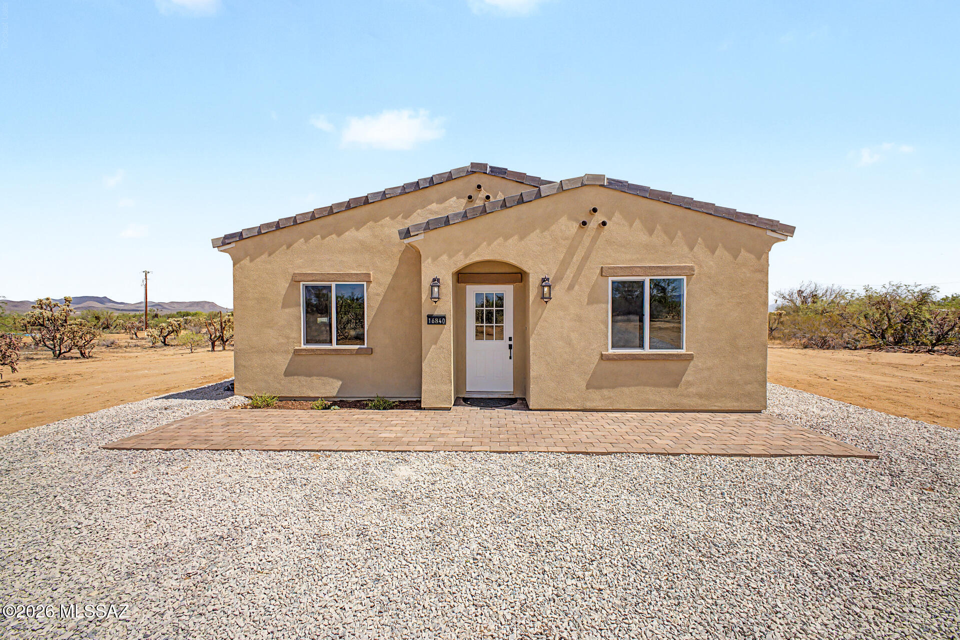 Brand new construction on over an acre with stunning mountain and desert views. Bordering Arizona State Trust Land, this property offers added privacy, open space views, and no neighbors directly in front of the home. The open-concept design features modern finishes and plenty of room for horses, RVs, toys, or future improvements. Enjoy the peace of country living while remaining just a short drive from Tucson's conveniences.