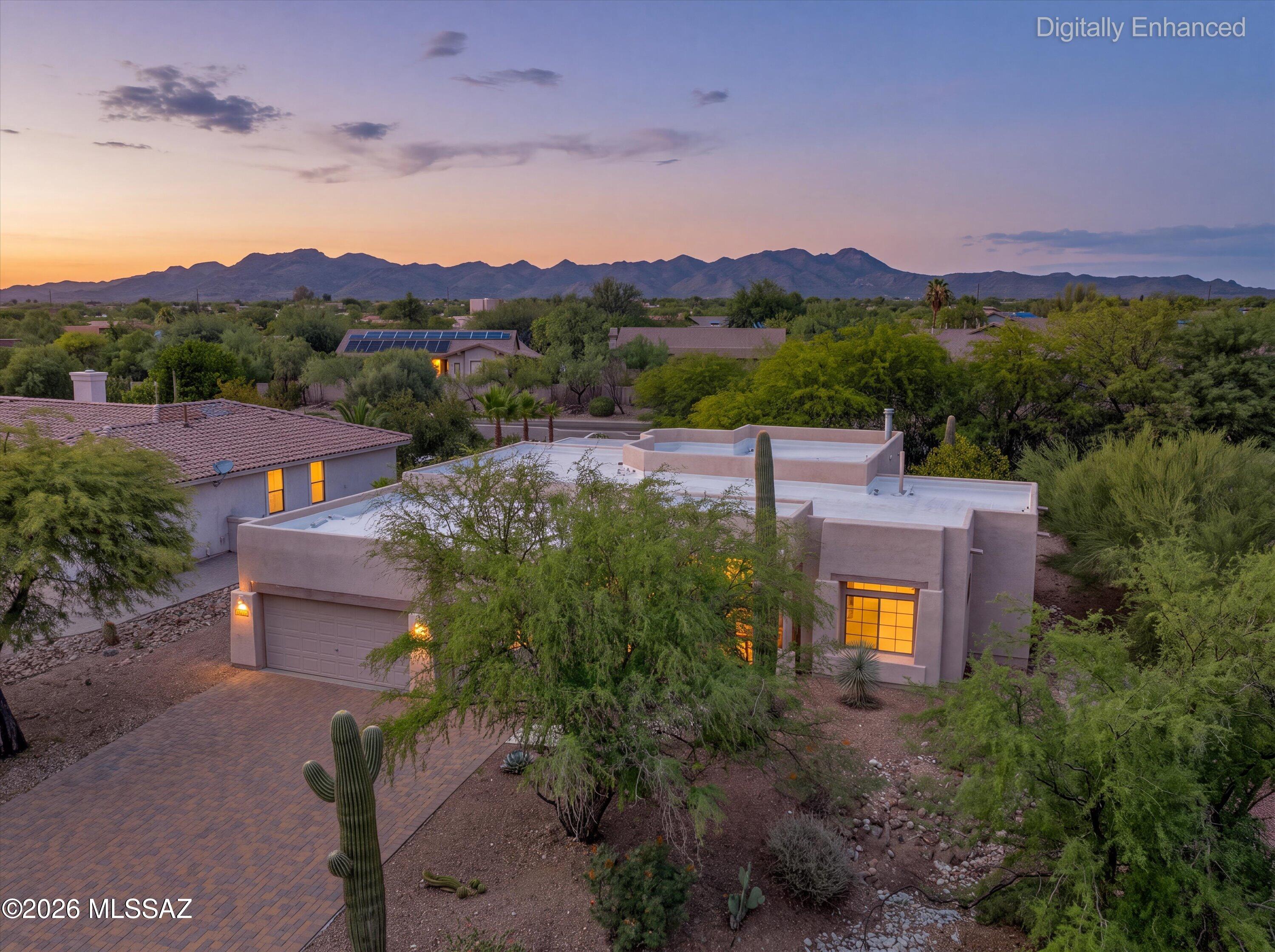 Space, privacy and classic Southwestern character come together in this inviting Oro Valley home set on more than a quarter acre in Desert Vista. With a desirable split-bedroom floor plan, brand-new carpet and a spacious 3-car garage, the home offers a comfortable, move-in-ready layout with plenty of room inside and out.
The bright great room is anchored by a classic beehive fireplace and opens to the kitchen and casual dining area, creating an easy flow for everyday living and entertaining. The kitchen offers generous cabinetry and counter space, a breakfast bar and adjoining dining nook, while a separate formal dining room provides additional flexibility for entertaining, working from home or creating another gathering space.
Privately positioned away from the secondary bedrooms, the primary suite features direct access to the backyard, a large walk-in closet and a spacious bath with dual vanity areas, soaking tub and separate shower. Two generously sized secondary bedrooms are located on the opposite side of the home.
The oversized north-facing backyard is a standout, offering a large covered patio, mature shade trees, artificial turf, established desert landscaping and a fire pit. With plenty of room to relax, entertain or create additional outdoor living areas, this spacious backyard is made for enjoying Arizona evenings.
Classic Santa Fe architecture, mature landscaping, a versatile floor plan and a 3-car garage complete this Oro Valley property, conveniently located near shopping, dining, recreation, golf and miles of hiking and biking trails.