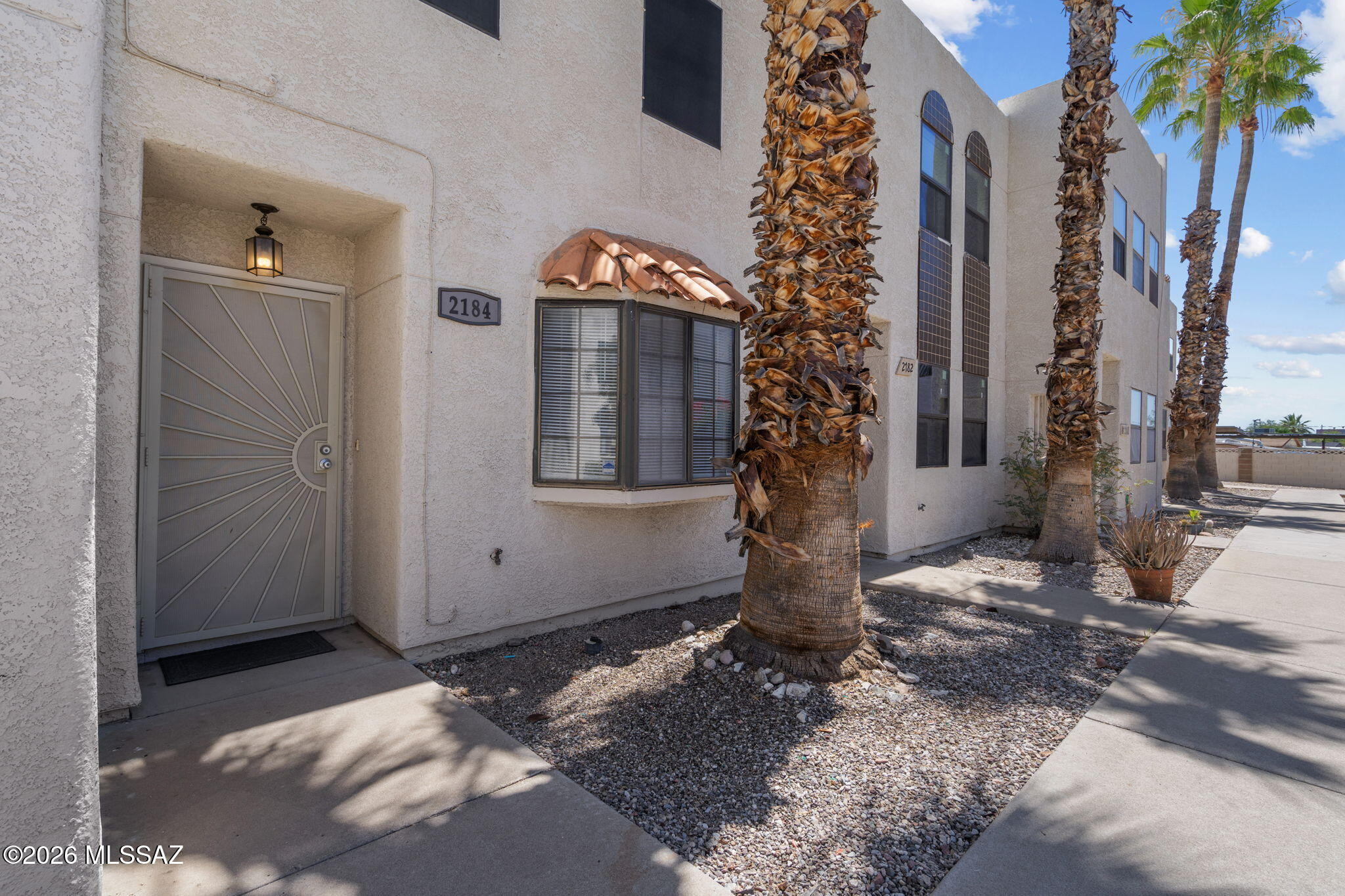 Located within walking distance of the University of Arizona, this 2-bedroom, 2-bath condo offers a safe and secure location for students and families alike. Enjoy easy access to campus, a nearby grocery store, and public transportation just steps away. Overlooking the community pool and open space, this home is move-in ready with new carpet throughout and on both the stairs and upstairs hallway. The kitchen comes fully equipped with all appliances included, and a new roof was installed in 2025.  This home includes one assigned covered parking space--perfect for convenient, low-maintenance living!