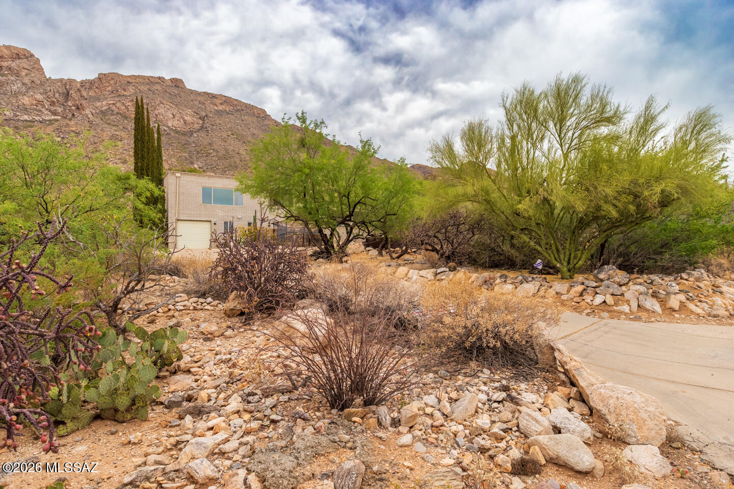 Amazing views, spacious floorplan, and beautiful pool! Come see this home in the sought after Catalina Foothills School District. The main house has 2 bedrooms, 2 baths, kitchen, living room, family room and dining room and 2 car garage. A large wraparound porch connects to the semi attached guest quarters with separate entrance and 1 car garage with workshop space. Guest quarters feature a living room, kitchenette, 2 bedrooms, 1 ½ baths and plenty of storage. The beautiful pool is the centerpiece of both living areas!