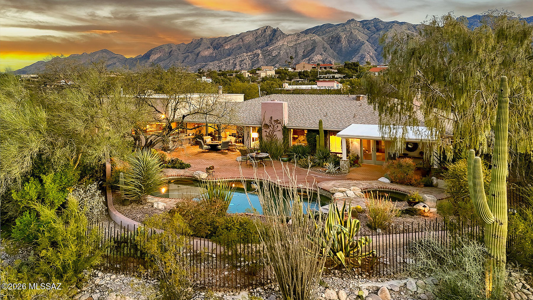 Astonishingly perfect setting-Elevated, Glittering City Light show, plus direct North Views of Catalina Splendor--Yes,very private, as well.Tastefully remodeled with no expense spared-One of the Best Kitchens in Tucson designed to cook and entertain guests, too. Huge windows frame the Award Winning rear Patio with its Pool/Waterfall Spa/Covered porches and Spectacular Views-Grand Family Room opens to Kitchen, a Fireplace is between 2 Sets of French Doors access North enclosed BBQ Patio, Clerestory Windows display the Catalinas-Primary Suite is a restful sanctuary with French doors to pool/ private patio, cozy sitting Area w/Fireplace, Updated Bath has wonderful built ins-A Well located Media Room could surely be a 4th Bedroom. (Pls check Document Tab for Amenity List and Floor Plan) Media Room/4th Bedroom has two walls of cabinets with pull outs galore, there is hanging space for clothing. Full Bath, again, is remodeled with lovely vanity, tub shower combo and easy access to two to 3 guest bedrooms. Powder room is, also, tastefully remodeled and tucked away giving guests privacy. Everyone will appreciate the size, location, window walls and built-ins that makes the Dining Room so exceptional! Fold away, disappearing sliders Open to the Patios and Pool and make the transition from inside to out seamless.  Ingenuity, taste, craftsmanship, and dedication created this beautifully designed home.