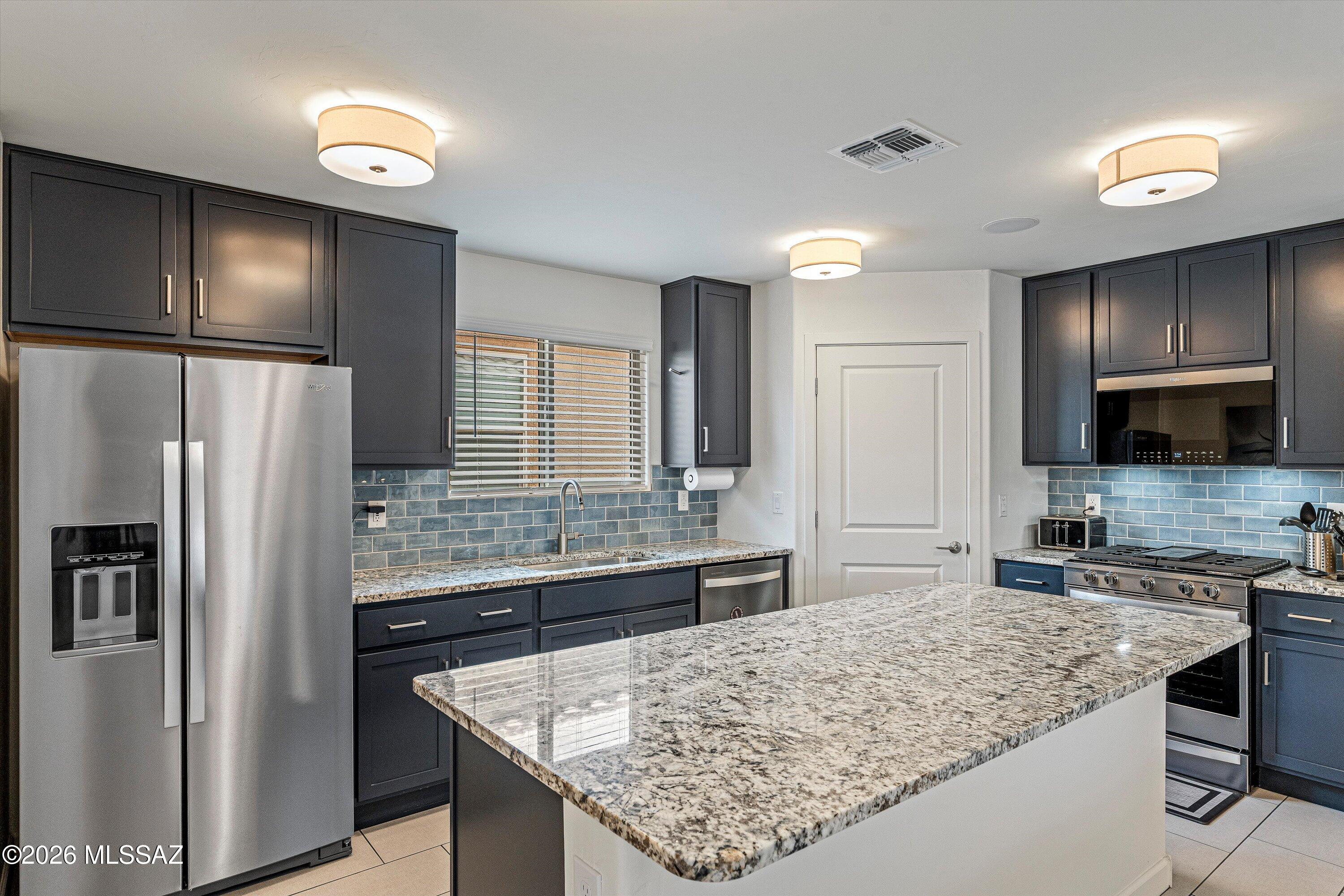 SELLER IS MOTIVATED! Bring your offer. Step into this 2025 expertly designed home that is perfect for everyday living and entertaining. The home features a spacious great room that flows seamlessly into the kitchen and dining areas. Stunning interiors with granite countertops, 4'' subway tile, stainless Whirlpool appliances, walk-in pantry. The primary suite provides a private retreat with an en-suite bath and walk-in closet. Additional bedrooms offer flexibility for guests, a home office, or growing families. Expect modern finishes with beautiful upgraded 42'' cabinets, insulated garage, upgraded R-38 ceiling, insulated interior walls, soft close doors and drawers, tasteful flooring, and upgraded lighting throughout. This home sits in one of Marana's top master-planned communities, renowned for its family-friendly vibe and extensive amenities. Residents enjoy:

Over 850 acres of lush green space
31 parks
25 playgrounds
Miles of paved walking/biking trails and landscaped paseos
Splash pads
Sports fields
Dog parks
Community events like concerts, food trucks, and holiday festivals

Gladden Farms emphasizes an active, connected lifestyle with easy access to schools, shopping (including nearby Fry's Marketplace), and outdoor recreation in the scenic Sonoran Desert. Marana is known for its safety, award-winning schools, and thoughtful growth.
Whether you're looking for a low-maintenance starter home, a family residence, or an investment in a rapidly growing area north of Tucson, this property delivers comfort, convenience, and community. Its prime location offers quick access to I-10, employment centers, and desert adventures while providing a peaceful suburban feel.