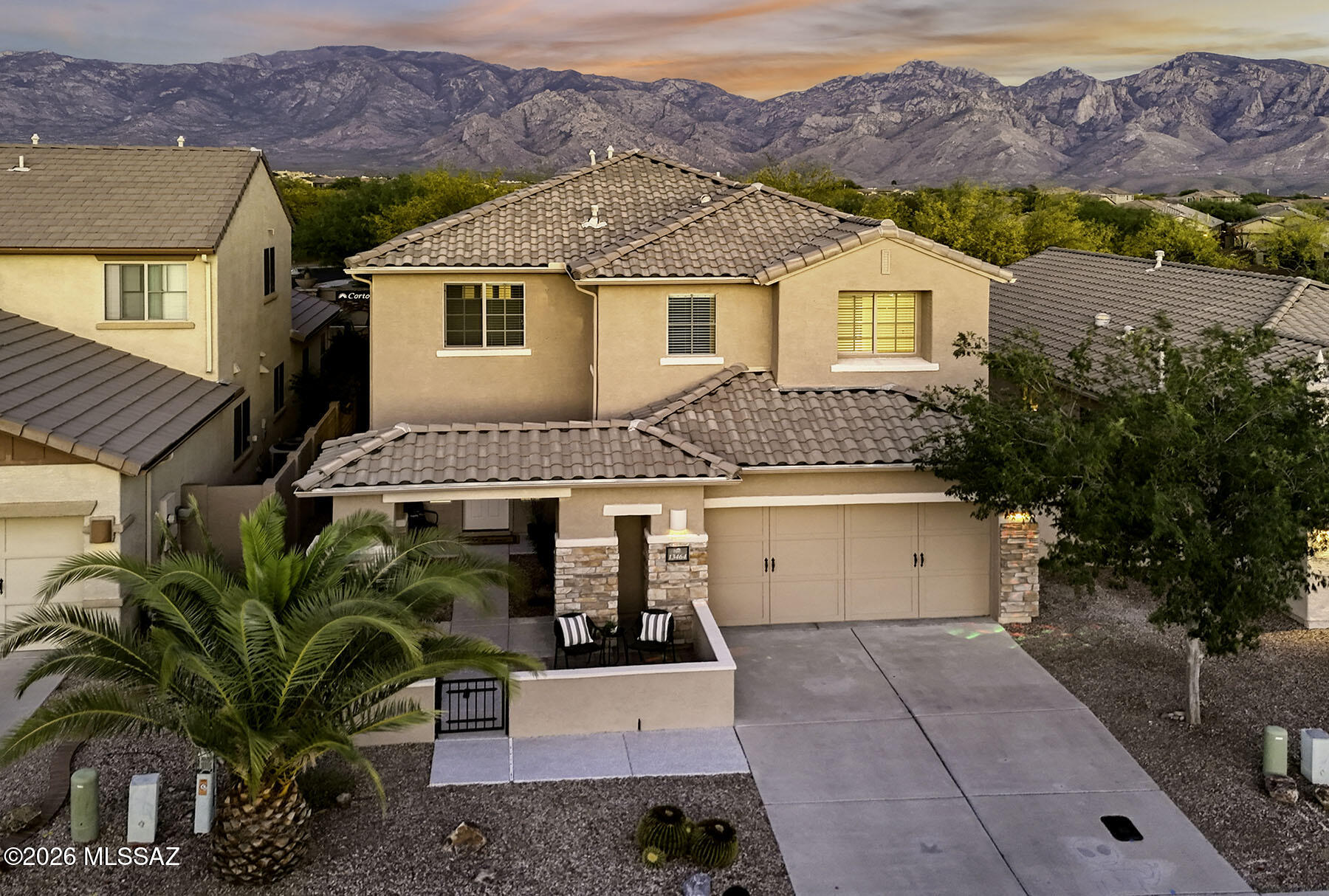 Step into luxury with this stunning former Pulte model home, thoughtfully upgraded and completely refreshed for today's modern lifestyle. From the moment you arrive, the freshly painted exterior, new concrete overlay walkway, and elegant tumbled stone columns create a warm, inviting entrance that sets the tone for what's inside. Boasting over 3,000 square feet of beautifully designed living space, this home features soaring ceilings and a bright, open layout. The interior has been meticulously updated with fresh paint and stylish 6-inch baseboards throughout the main level--no detail has been overlooked. At the heart of the home,
the well-appointed kitchen shines with new quartz countertops, designer backsplash, pendant lighting, and a GE range. A massive work island with breakfast bar, abundant cabinetry, and stainless steel appliances make it perfect for both everyday living and entertaining--all seamlessly opening to the spacious family room. Upstairs, a versatile loft has been converted into a 
flexible fifth bedroom, home office, or creative space, adapting easily to your needs. The primary suite is a true retreat, featuring a spa-inspired bathroom with a custom oversized shower room, luxurious soaking tub, and designer tile finishes. The renovated guest bath offers a fresh, modern touch for family and visitors alike. Car enthusiasts and organizers alike will appreciate the 3-car tandem garage, complete with extensive built-in storage shelving. Step outside to your private backyard oasis, where breathtaking Catalina Mountain views provide a stunning backdrop. Enjoy outdoor living at its finest with a NEW built-in BBQ, alfresco cooking area, paved patios, and low-maintenance artificial turf--all perfectly positioned with ideal east-facing exposure. Located near top-rated Vistoso schools, scenic parks, and bike paths, this 
move-in ready home offers the perfect blend of comfort, style, and convenience.
This is Arizona living at its finest--don't miss your opportunity to make it yours!