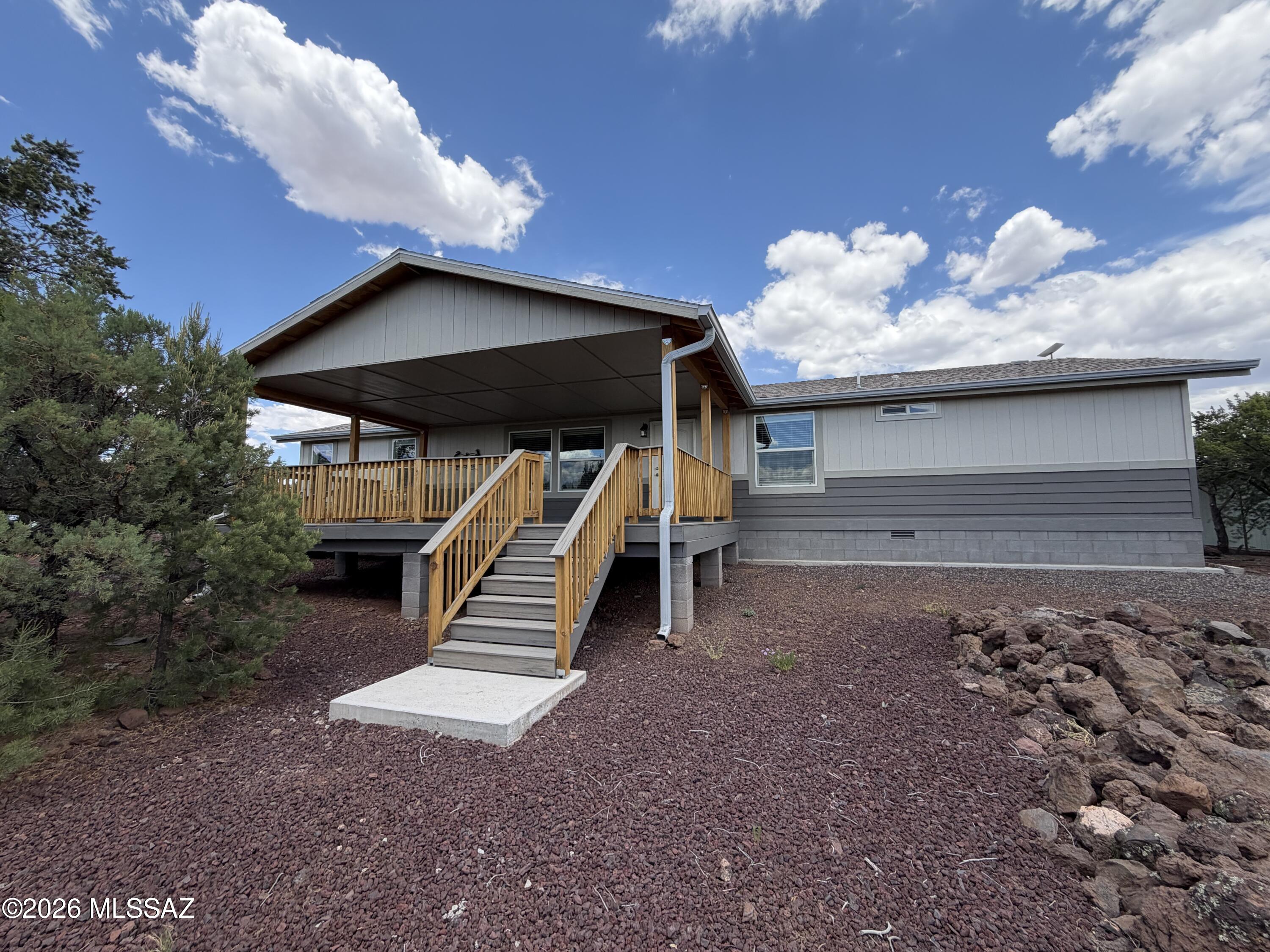Set on over 2 picturesque acres with stunning mountain views & sweeping views of Ortega Draw, this beautifully maintained property offers the perfect blend of comfort, space & charm. Designed with both functionality & style in mind, the home features 3 beds, 2 baths, plus separate living & family/bonus rooms for flexible living or entertaining. The impressive kitchen is the heart of the home with a massive 9' x 4½' island, SS appliances, Corian counters, gas range, walk-in pantry & upgraded staggered cabinetry w/crown molding. Quality upgrades throughout include 2x6 construction, vaulted ceilings, modern lighting, ceiling fans, plush carpet & wood plank vinyl flooring. Step outside to enjoy Arizona living at its best from the oversized covered 25' x 16' Trex front deck or the 24' x 12' Trex backyard deck perfectly positioned to capture the incredible views. The property is fully equipped for hobbies, storage & outdoor living with his & her sheds/workshops, greenhouse, RV parking with water, septic access & both 30 & 50 amp hookups. A truly special move-in ready property offering privacy, views & room to enjoy it all!
