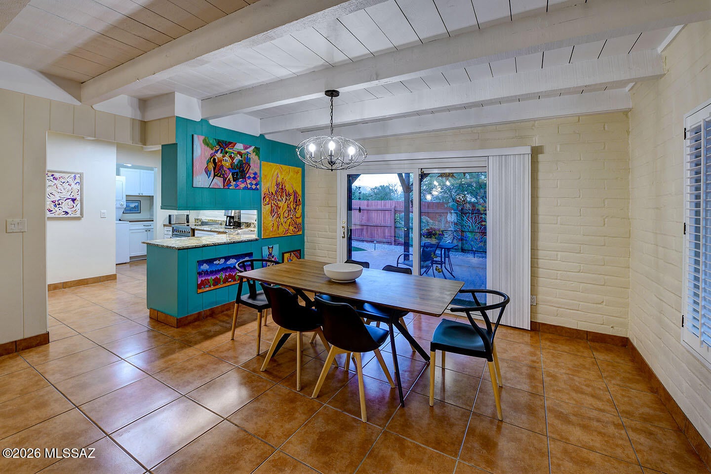OPEN SUN 10/18, 2-4! Charm of the '60's! Absolutely darling 2 BR/1 BA burnt adobe condo in ''the Ranch'' right next to Tucson Racquet Club & the Riverwalk! This adorable mid-century home boasts 2 front ''carporches'', open floorplan, high beamed ceiling throughout, tile floors (no carpet) w/ custom designed wooden inlay, cozy fireplace w/ wood mantle & tiled hearth, plantation shutters, new light fixtures & ceiling fans, updated kitchen w/ stainless steel appliances, granite counters, a convection oven, hideaway microwave & pullout pantry drawers, triple paned windows & lovely low care yard w/ brick patio, 2 shade structures, faux grass, colorful mural & Catalina views! This park like community of 45 homes sits on a former historic Tucson ranch. Check out the community racquet shaped pool!