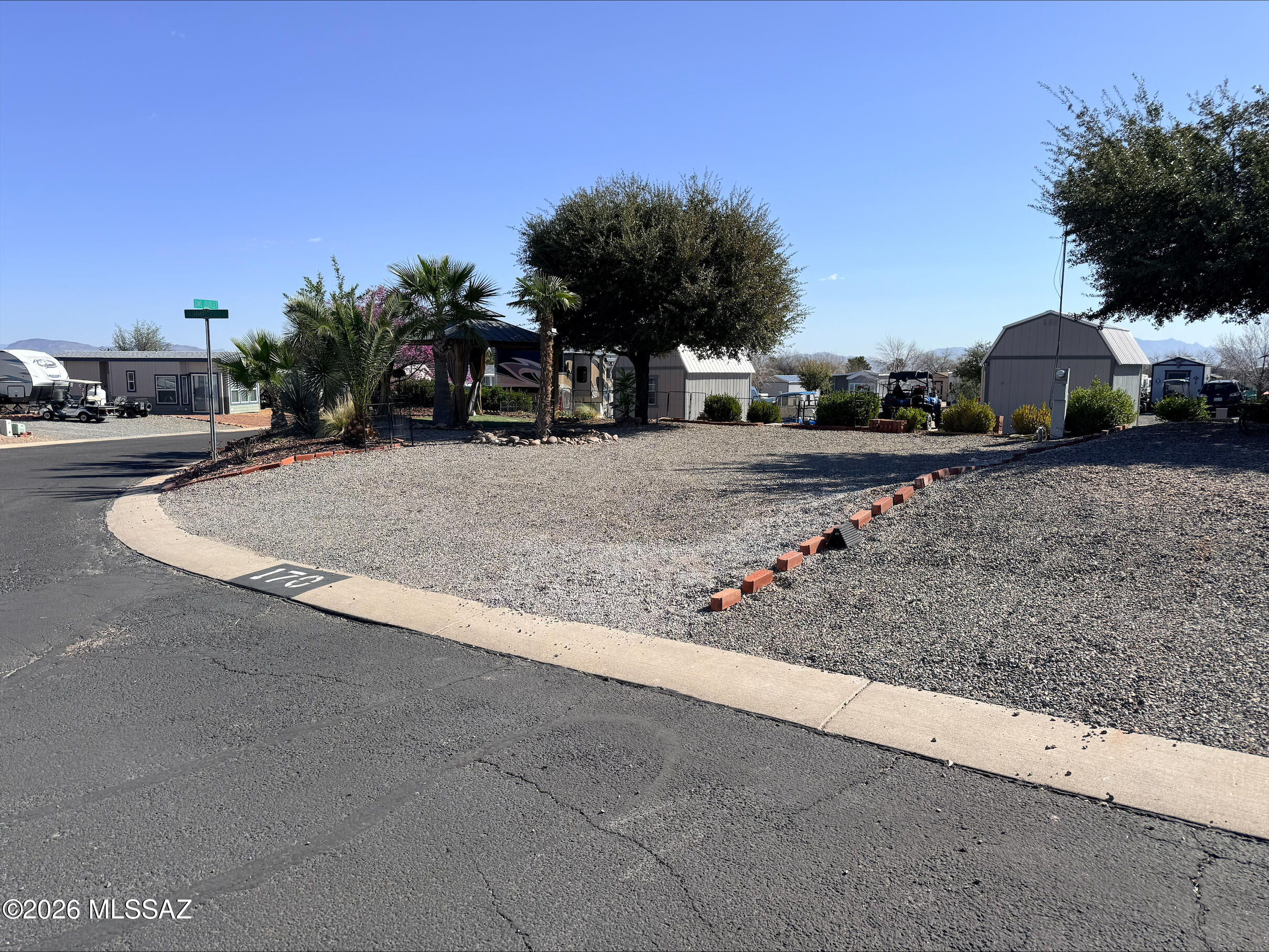Exceptional corner lot available in a highly desirable RV resort community. Surrounded by beautifully maintained landscaping with a gazebo set up, this site easily accommodates a large RV and provides ample room to enjoy outdoor living. Resort amenities include a pool, spa, fitness center, paved streets and a dog park., creating the perfect setting for comfortable and active resort living.