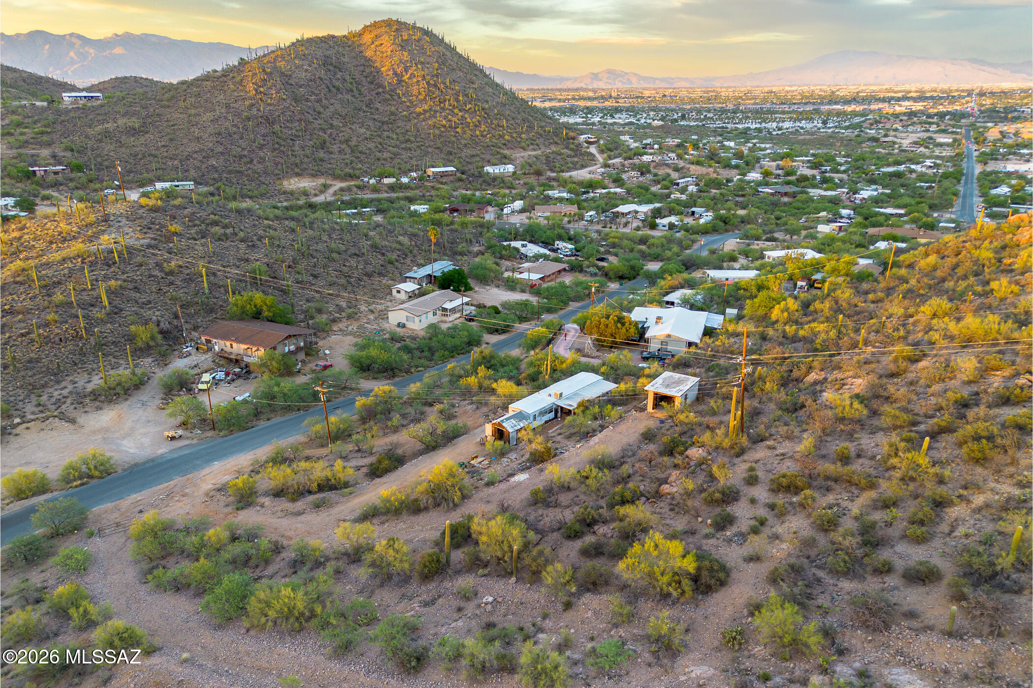 This lot at 2445 Irvington Place in Tucson offers a remarkable canvas for your dream build. Zoned SH with water, electric, and gas utilities already available on-site, the groundwork is set for seamless construction. Take in stunning city views that shimmer after sunset and distant mountain vistas that frame the desert horizon. A new community park is taking shape nearby, while Kennedy Park and Target Grocery along Irvington Road provide everyday convenience just minutes away. The Mission/Ajo bus station keeps you connected throughout Tucson. Real potential awaits in this up-and-coming neighborhood.