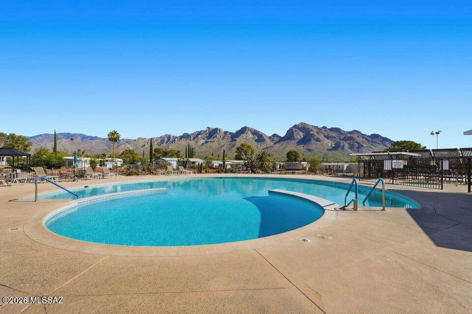 No Application Fees! Live in the heart of the Catalina Foothills at The Highlands in Oro Valley, a gated active adult community with resort-style amenities including a clubhouse, fitness center, heated pool and spa, tennis and pickleball courts, social activities, and access to a scenic championship golf course and nearby hiking trails. This 3 bedroom, 2 bathroom home features an extended carport, charming front porch, and a spacious Arizona room with panoramic mountain views. The kitchen offers well-maintained cabinetry, ample countertop space, and includes all appliances. The home also includes a washing machine and dryer for your convenience. All Denali Real Estate residents are automatically enrolled in the Resident Benefits Package (RBP) for $55.00/month which includes Renter's Liability Insurance, Credit Building to help boost the resident's credit scores with timely rent payments, up to $1M Identity Theft Protection, HVAC air filter delivery (for applicable properties), our best-in-class resident rewards program, and much more!