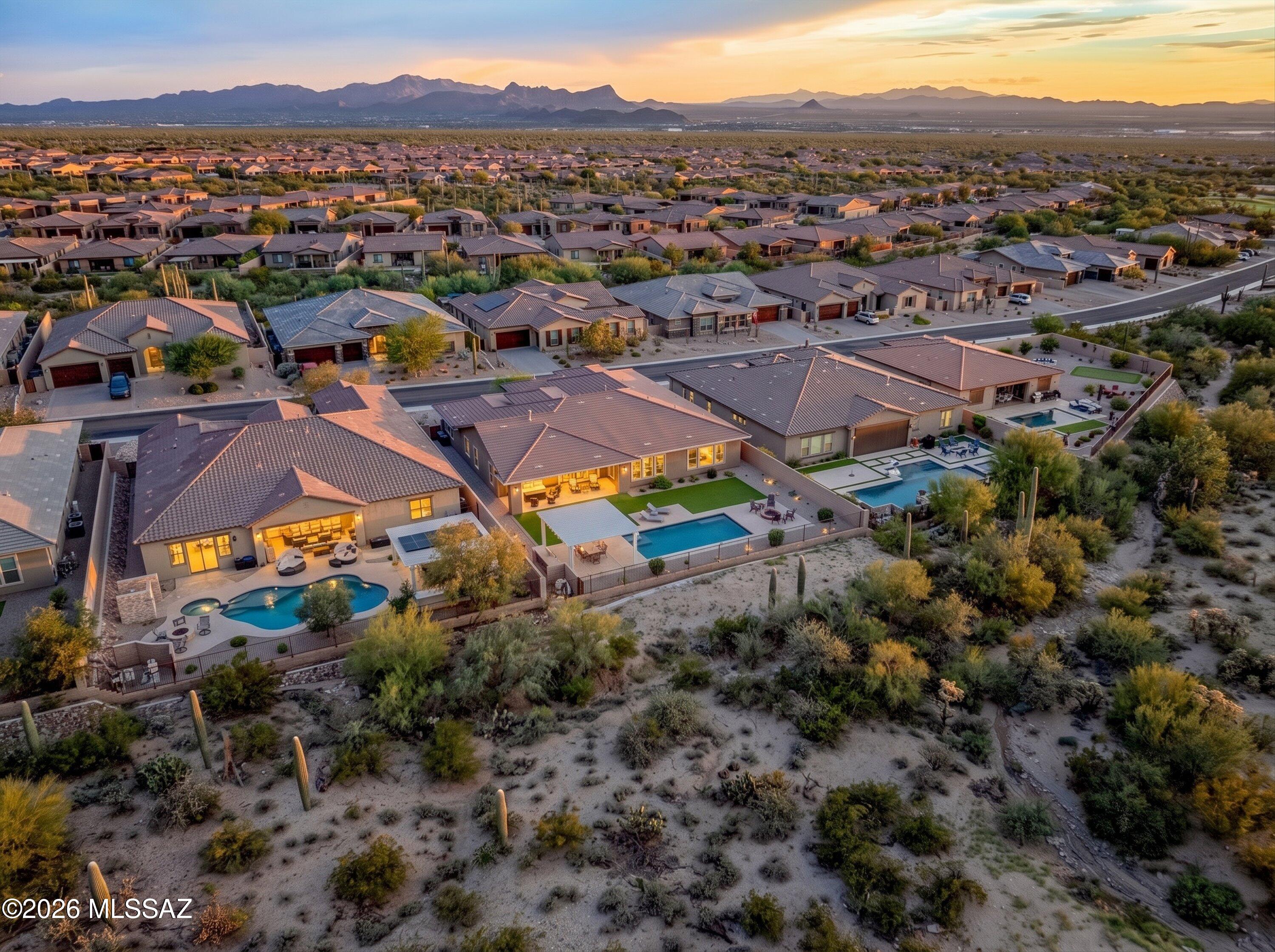 Experience elevated Arizona living in this exceptional Dove Mountain golf-course residence, showcasing breathtaking unobstructed views of the mountain and golf course with sophisticated indoor-outdoor living. This spacious 4-bedroom, 4.5-bath home features soaring cathedral ceilings in the great room and media room, with the media room highlighted by a gas fireplace and a beautiful stone surround. The home also offers an impressive oversized kitchen island, an eat-in kitchen, a formal dining area, and a private office with a unique hidden room--an unexpected and intriguing bonus. The luxurious primary suite offers a serene extended retreat, a generous walk-in closet, and a spa-inspired bath with a large walk-in shower and separate vanities. California Closet systems throughout the pantry and all closets provide exceptional organization and thoughtful storage. Hunter Douglas blinds throughout add a refined finishing touch, while elegant tile flooring with carpeted bedrooms provides comfort and style. The garage features custom cabinetry and professionally finished floor coating, creating a polished and highly functional space.

Step outside to your private resort-style oasis featuring a heated saltwater pool, a gas fire pit, and a covered BBQ area, all set against spectacular mountain and golf course vistas. Carefree desert landscaping with a drip irrigation system completes this beautifully appointed Dove Mountain retreat--an exceptional setting for relaxing, entertaining, and enjoying the best of Arizona living.
