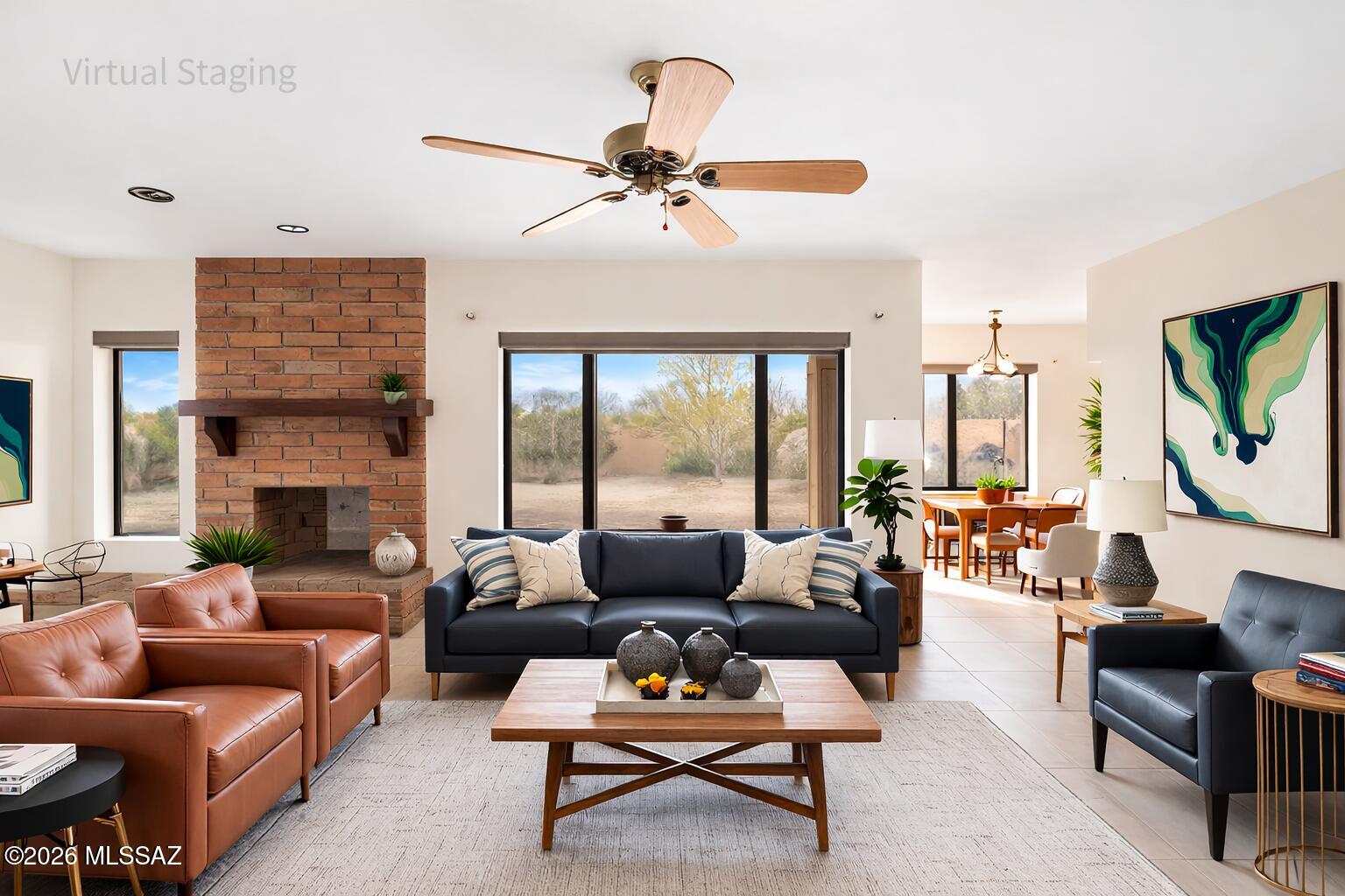 Set on over 3 beautiful acres, this exceptional home offers a rare combination of privacy, breathtaking mountain views, and timeless Southwestern character. Surrounded by natural desert landscape and located in a quiet, peaceful neighborhood, the property captures the beauty of Southern Arizona living while still being conveniently close to shopping, dining, and everyday amenities.
Inside, the home welcomes you with bright, open living spaces filled with natural light and warm architectural details that blend Southwestern charm with modern style. The spacious living room is anchored by a stunning brick fireplace, creating a cozy and inviting focal point perfect for relaxing evenings or gathering with family and friends. Large windows throughout the home frame the surrounding desert