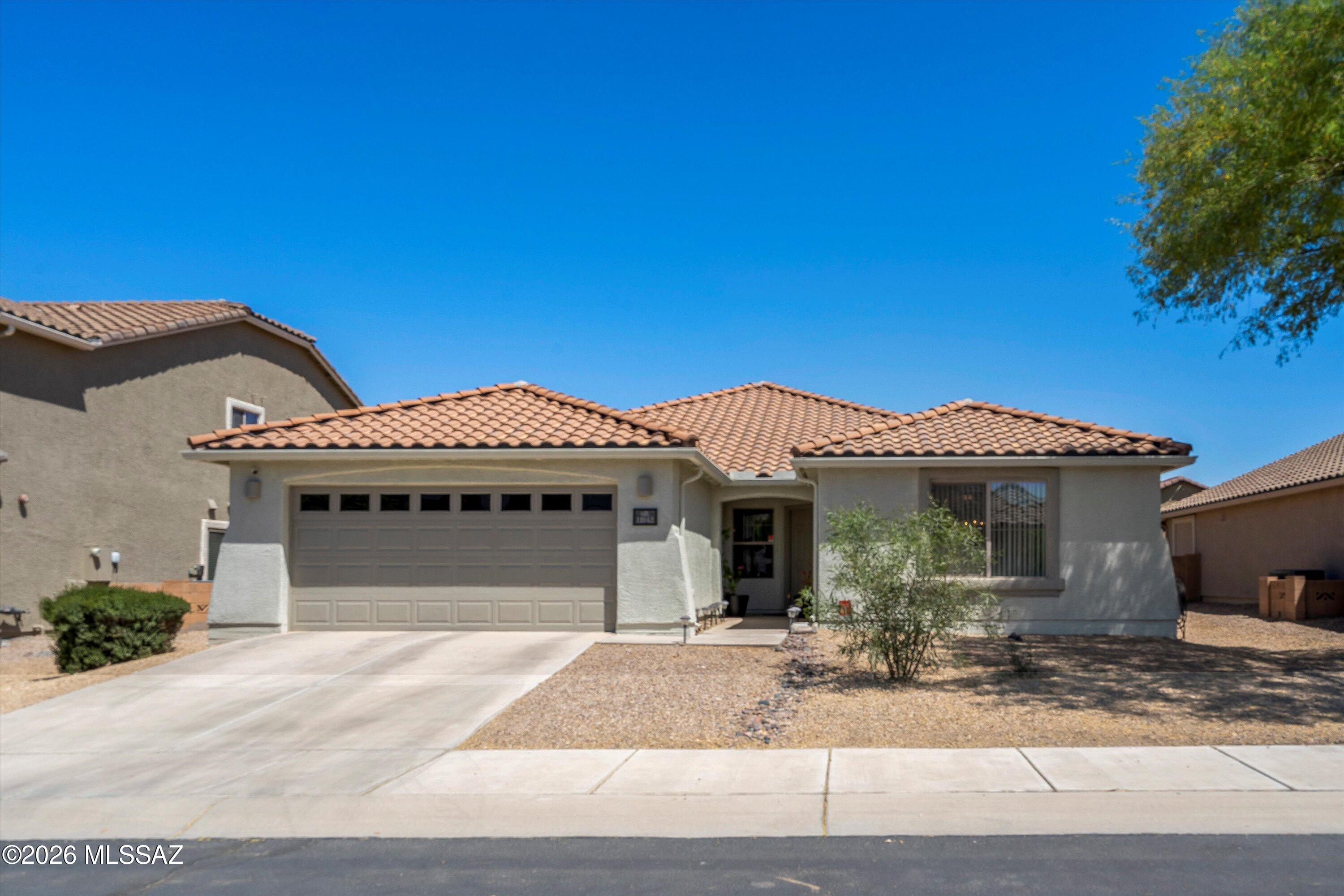 Welcome to this beautifully maintained 4-bedroom, 2-bathroom single-family home nestled in the desirable Gladden Farms community in Marana, AZ. Offering 2,379 square feet of thoughtfully designed living space on a 7,492 square foot lot with a south-facing front, this contemporary home is the perfect blend of comfort and style. Step inside to discover an open and inviting floor plan featuring a spacious family room, living room, and a dedicated dining area with a breakfast bar, ideal for both everyday living and entertaining. The kitchen is a true highlight, boasting quartz countertops, a kitchen island, electric range, dishwasher, disposal, microwave, and a closet pantry for ample storage. The primary suite offers a private retreat with a walk-in closet and an en-suite bath with a shower. The second bathroom features a shower and tub combo. Throughout the home you will find a mix of ceramic tile and carpet flooring, ceiling fans, double pane windows, and a dedicated laundry room for added convenience.
Step outside to enjoy a covered patio with low-maintenance landscaping, decorative gravel and desert plantings in front, and artificial turf with decorative gravel in the rear, all enclosed by a block fence for privacy.
Additional highlights include a 2-car attached garage with cabinets, central air and forced air heating, electric water heater, and high-speed internet availability.
Residents of Gladden Farms enjoy access to community amenities including a basketball court, jogging and bike paths, walking trails, sidewalks, and paved streets.